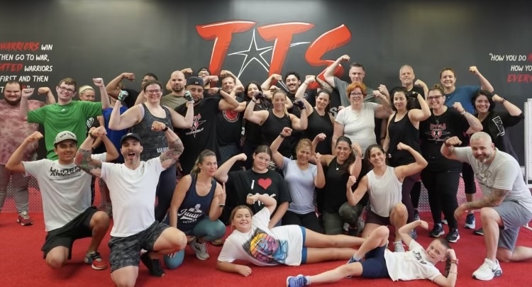 Tutela Training Systems members and athletes posing together in Clark, NJ
