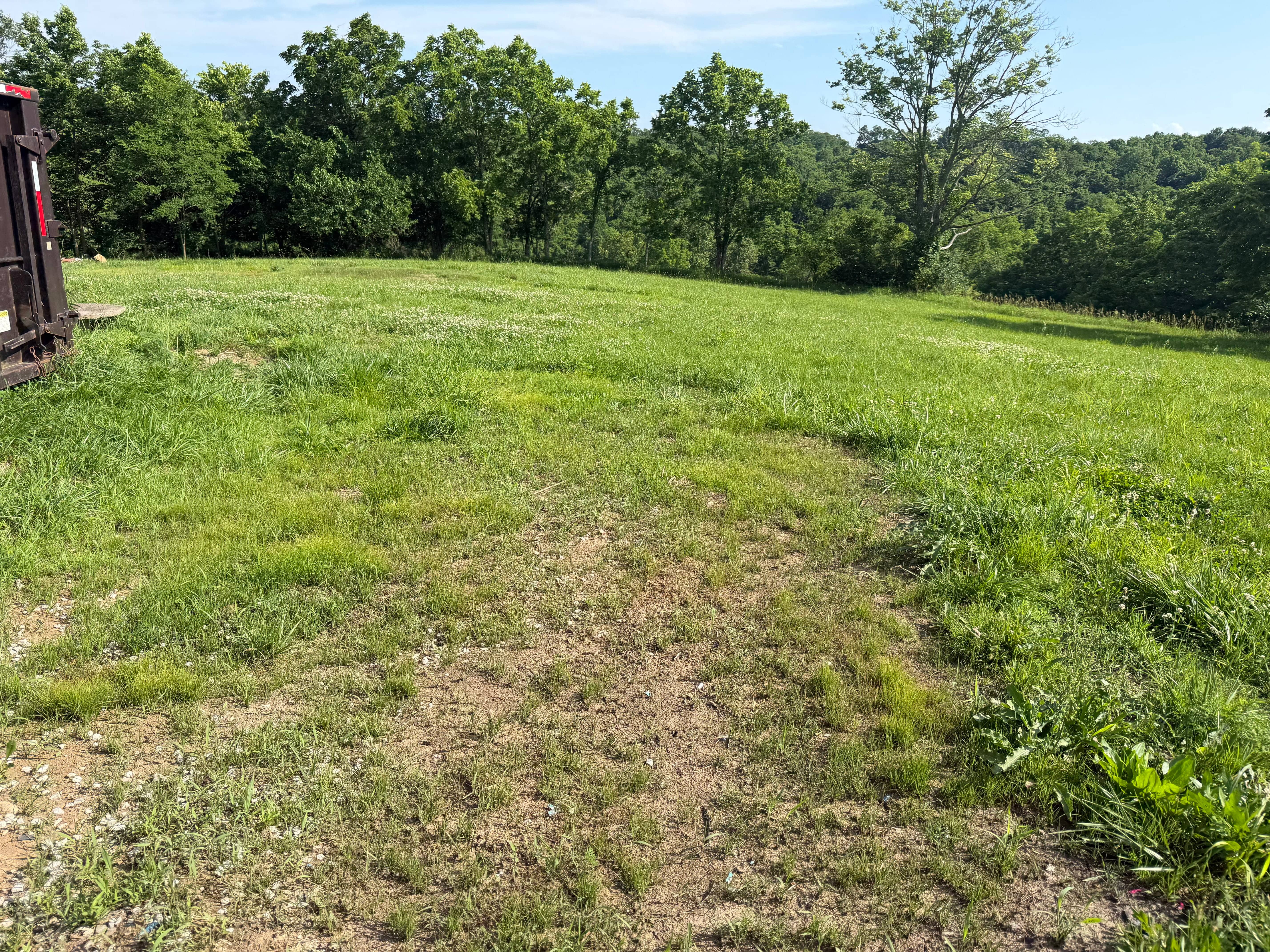 After clearing: green pasture restored, debris hauled off and site cleared
