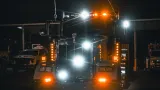 Heavy wrecker / recovery truck night-ops high-intensity scene and perimeter warning lights lit up after dark