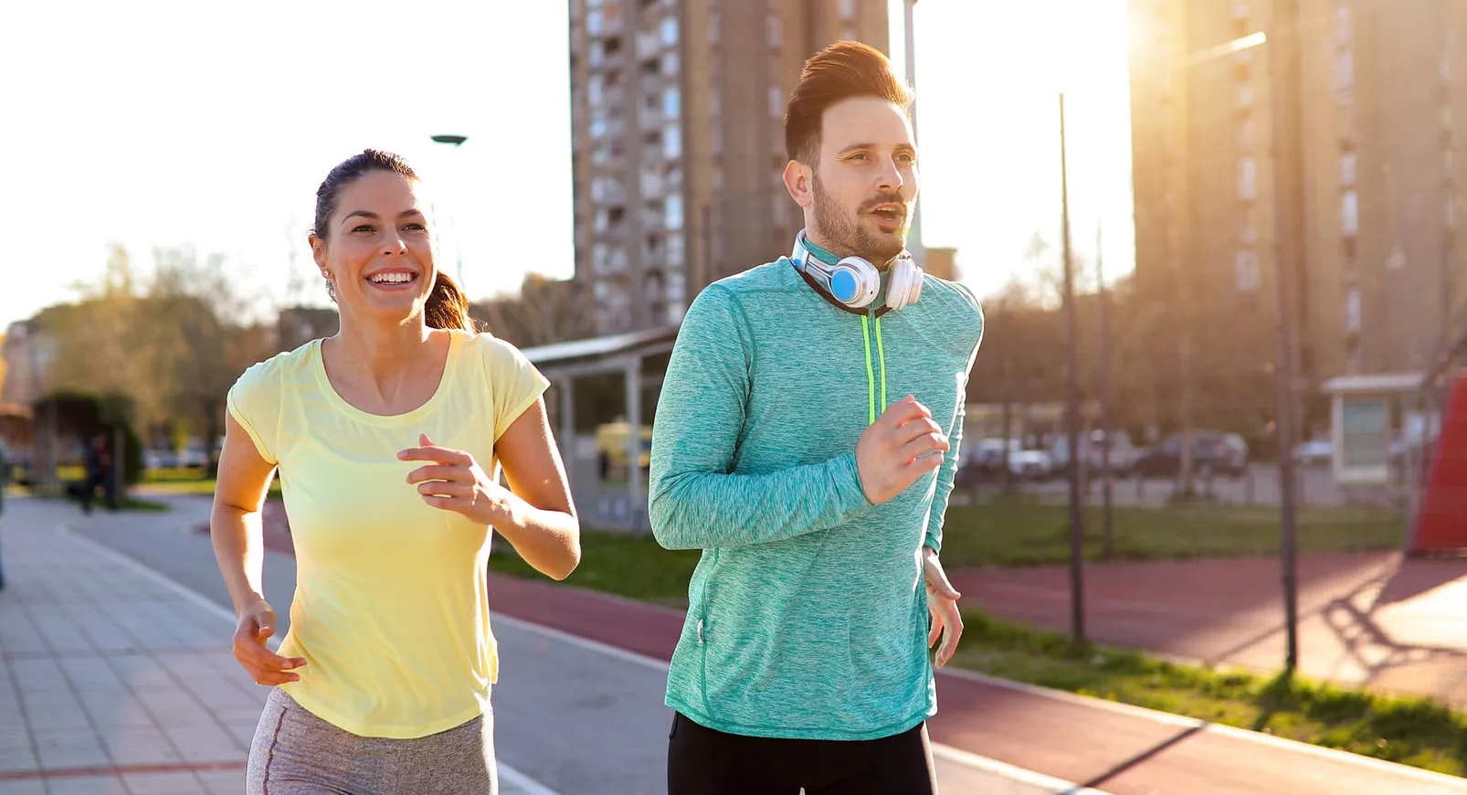 Active couple running outdoors without pain