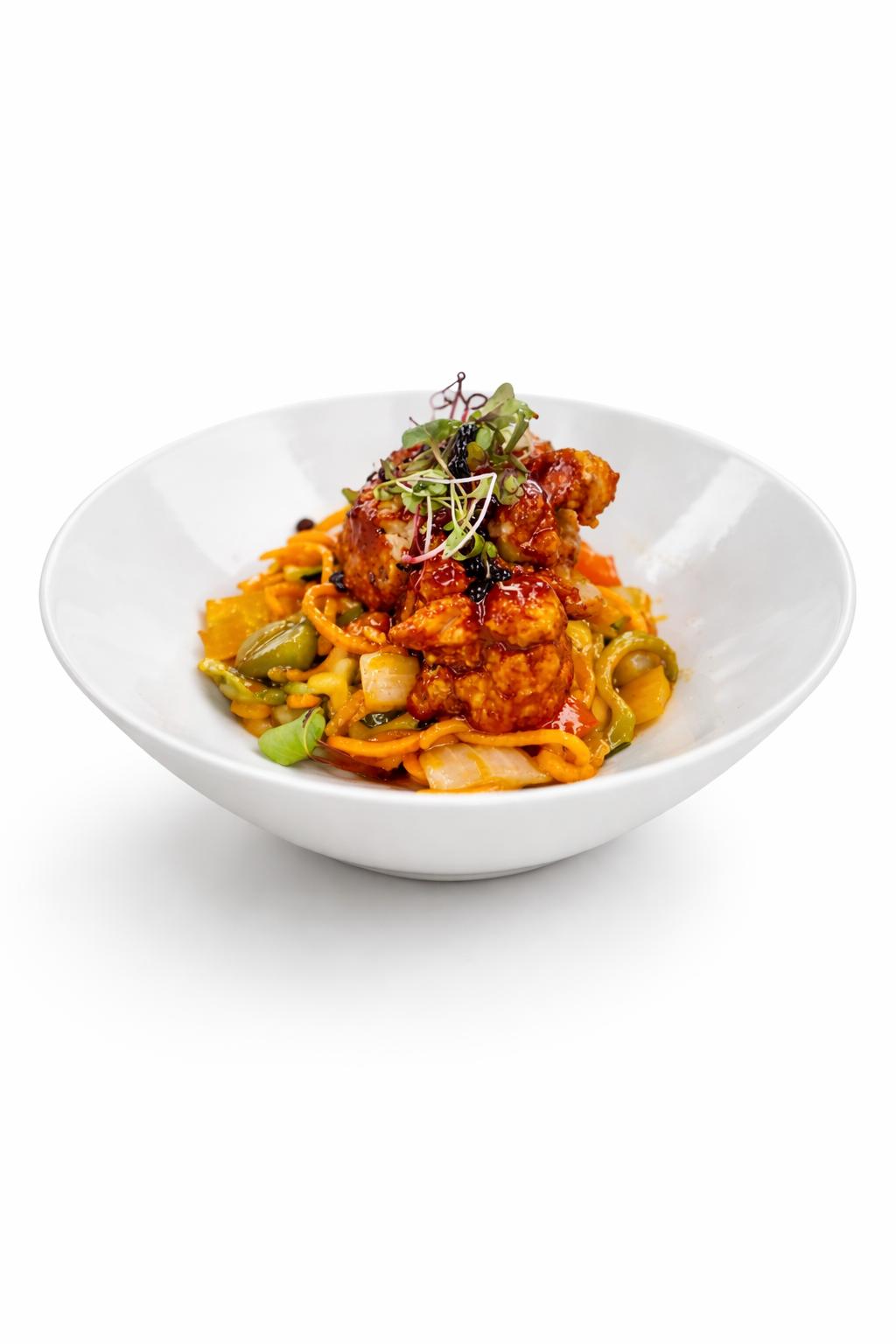 Asian-style noodle bowl with glazed cauliflower, vegetables, and microgreens