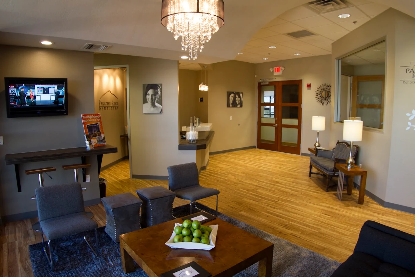 Spacious patient lounge with chandelier and seating area