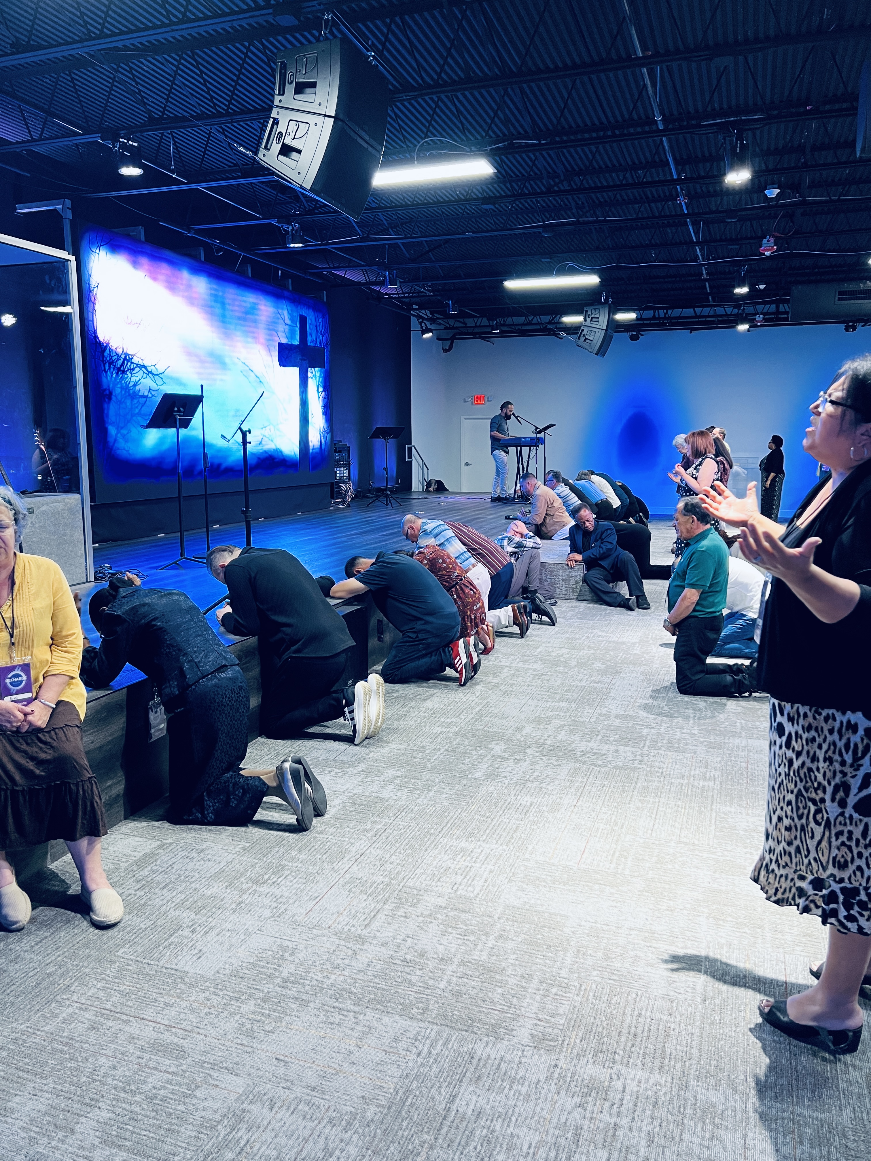 Leaders praying along the platform and altar