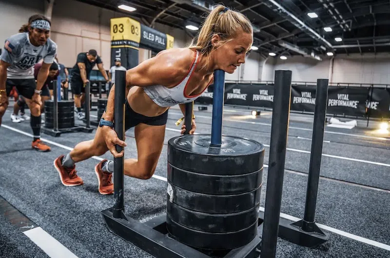 LMNT Active athletes pushing sled on turf in HYROX training