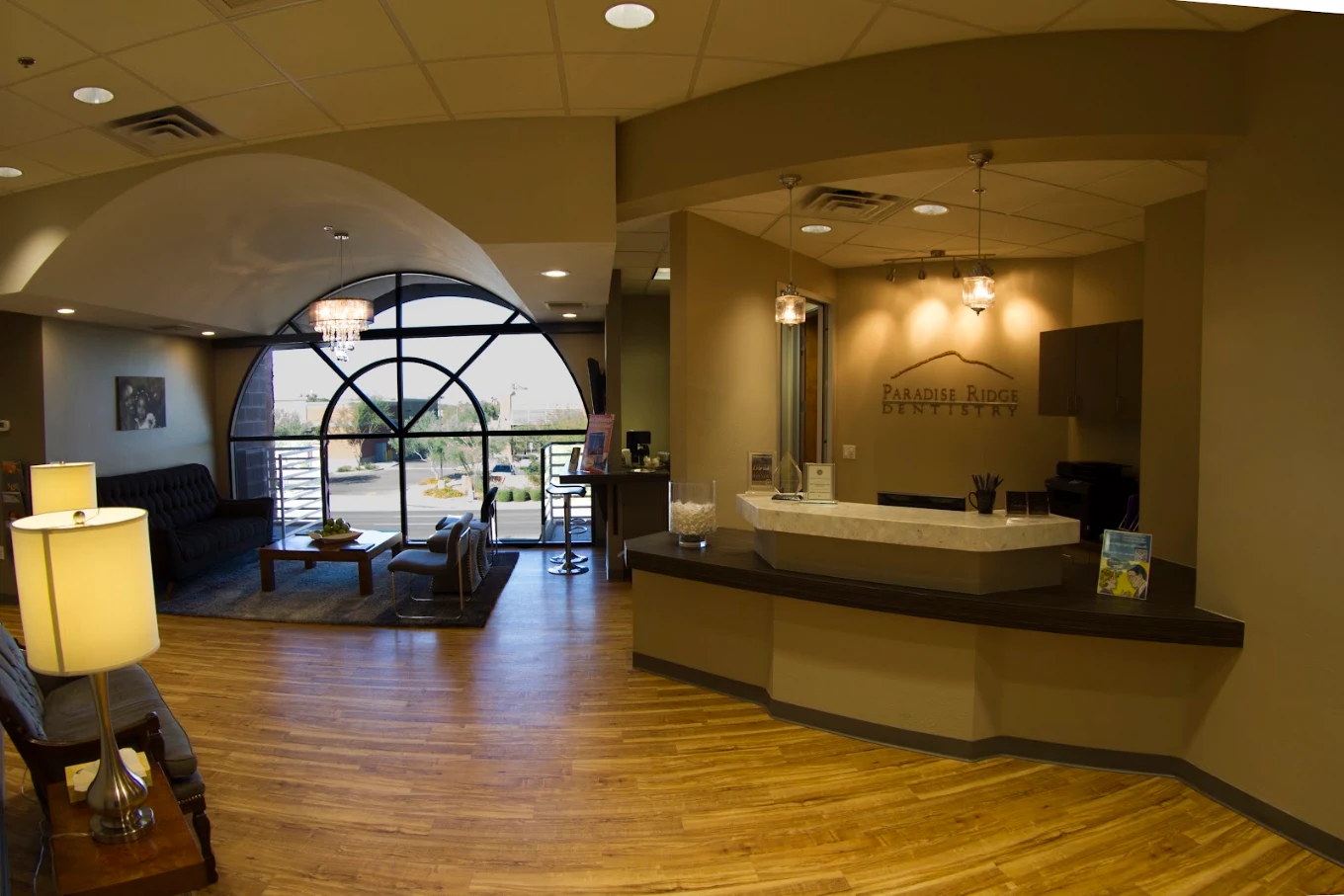 Modern lobby, check-in desk, and arched windows at Paradise Ridge Dentistry