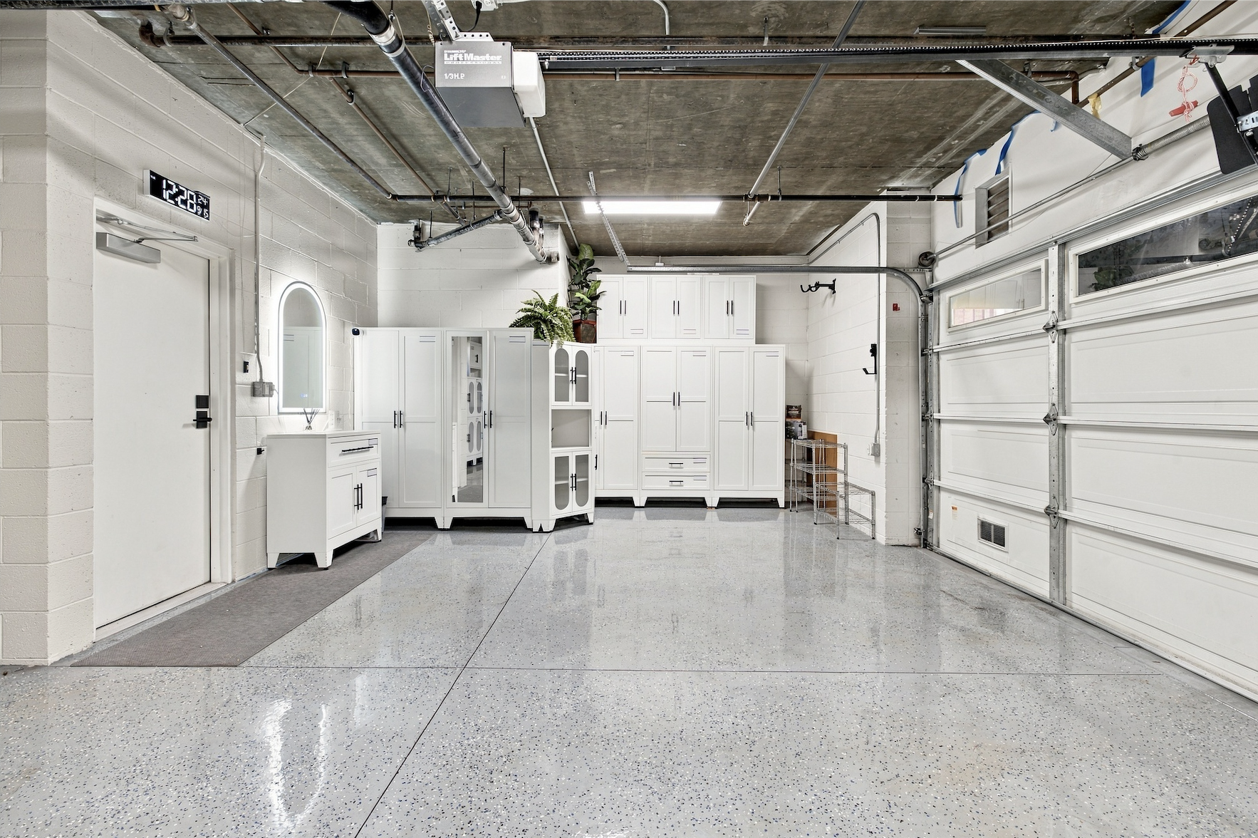 Spacious private 2-car garage with pristine epoxy floors and custom built-in cabinetry
