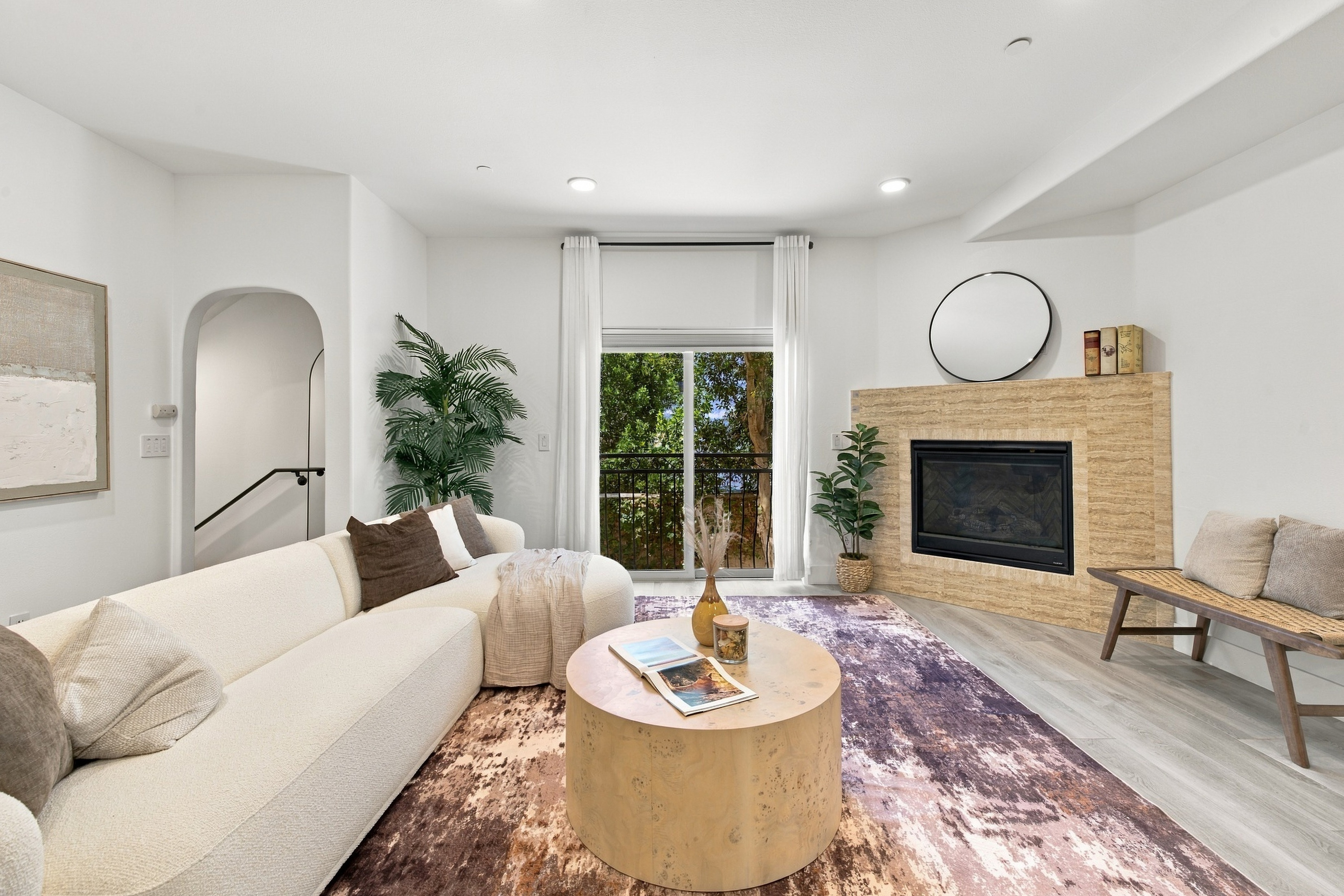 Living room view highlighted by warm natural light and sleek fireplace