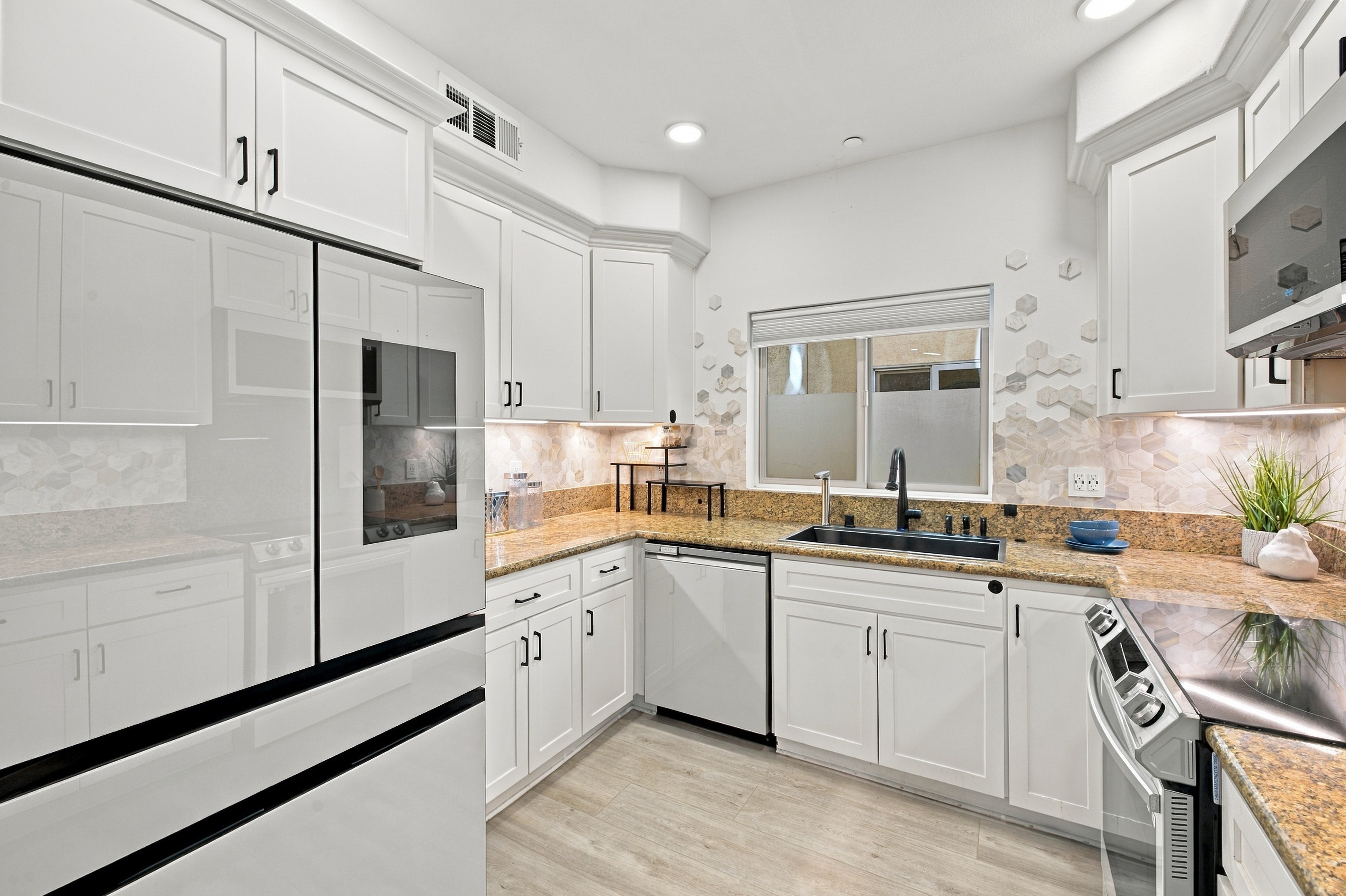 Kitchen overview with premium refrigerator and ample pantry storage