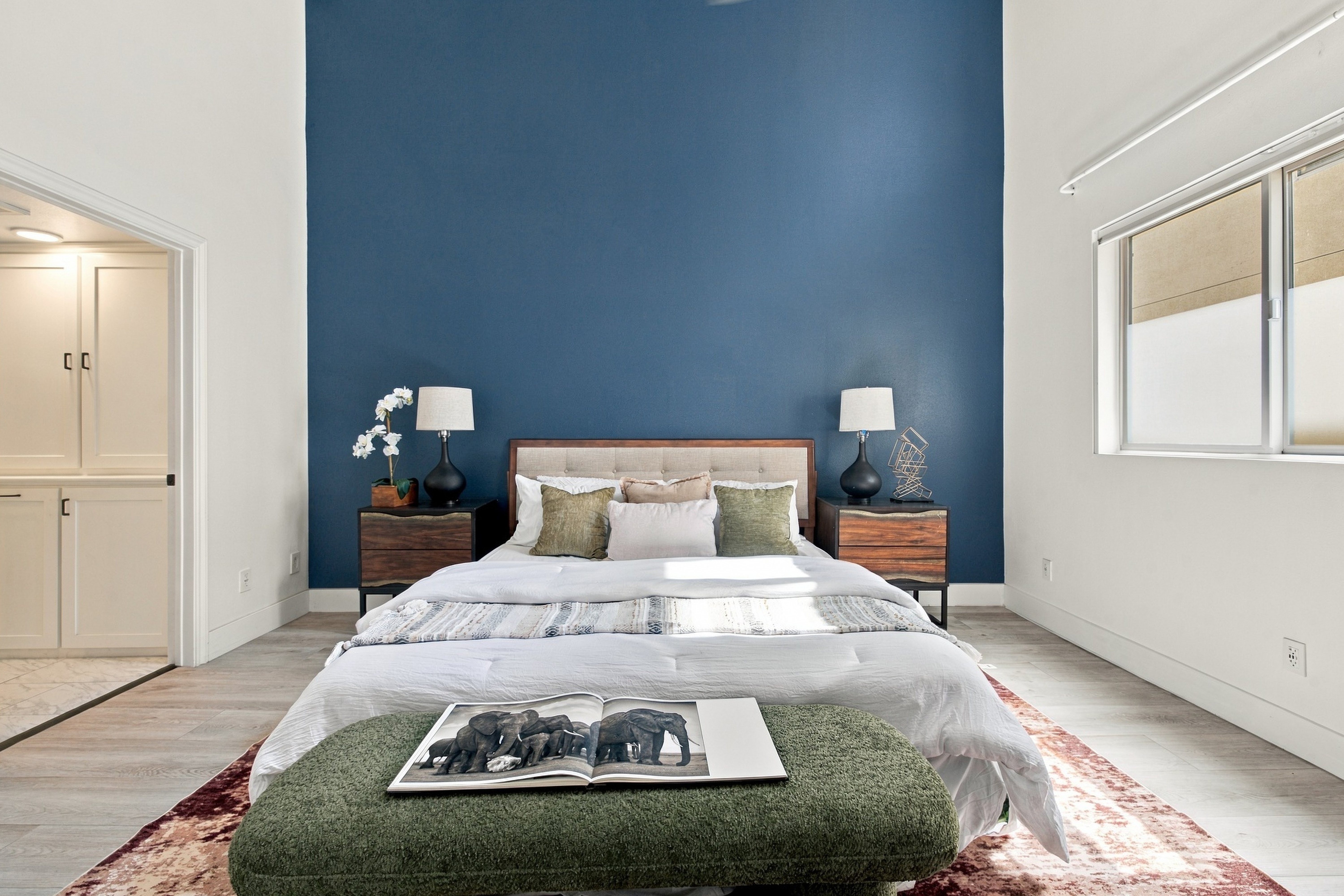 Spacious primary suite with designer lighting and ensuite bath entry