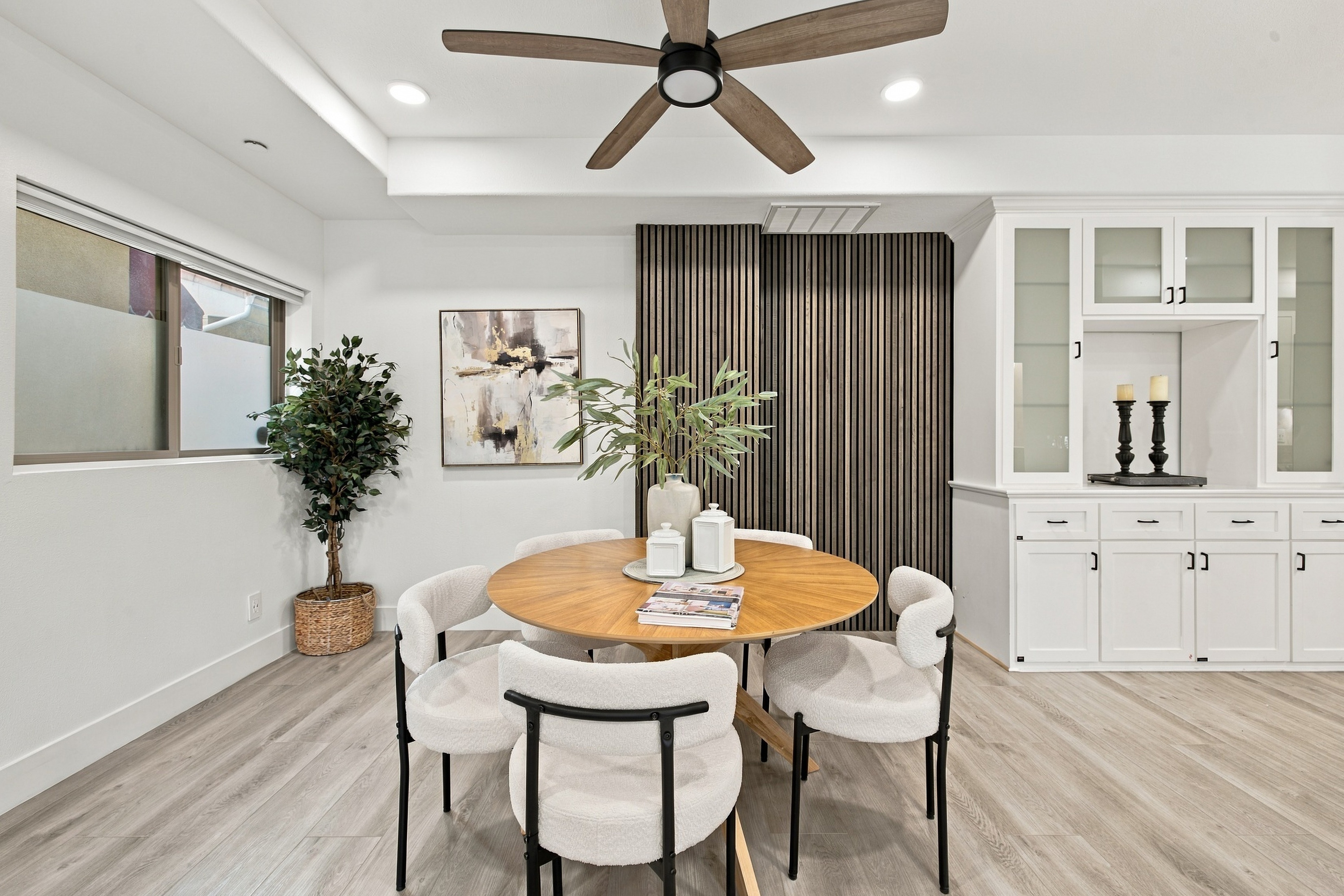 Dedicated dining space featuring vertical wood slat architectural accent