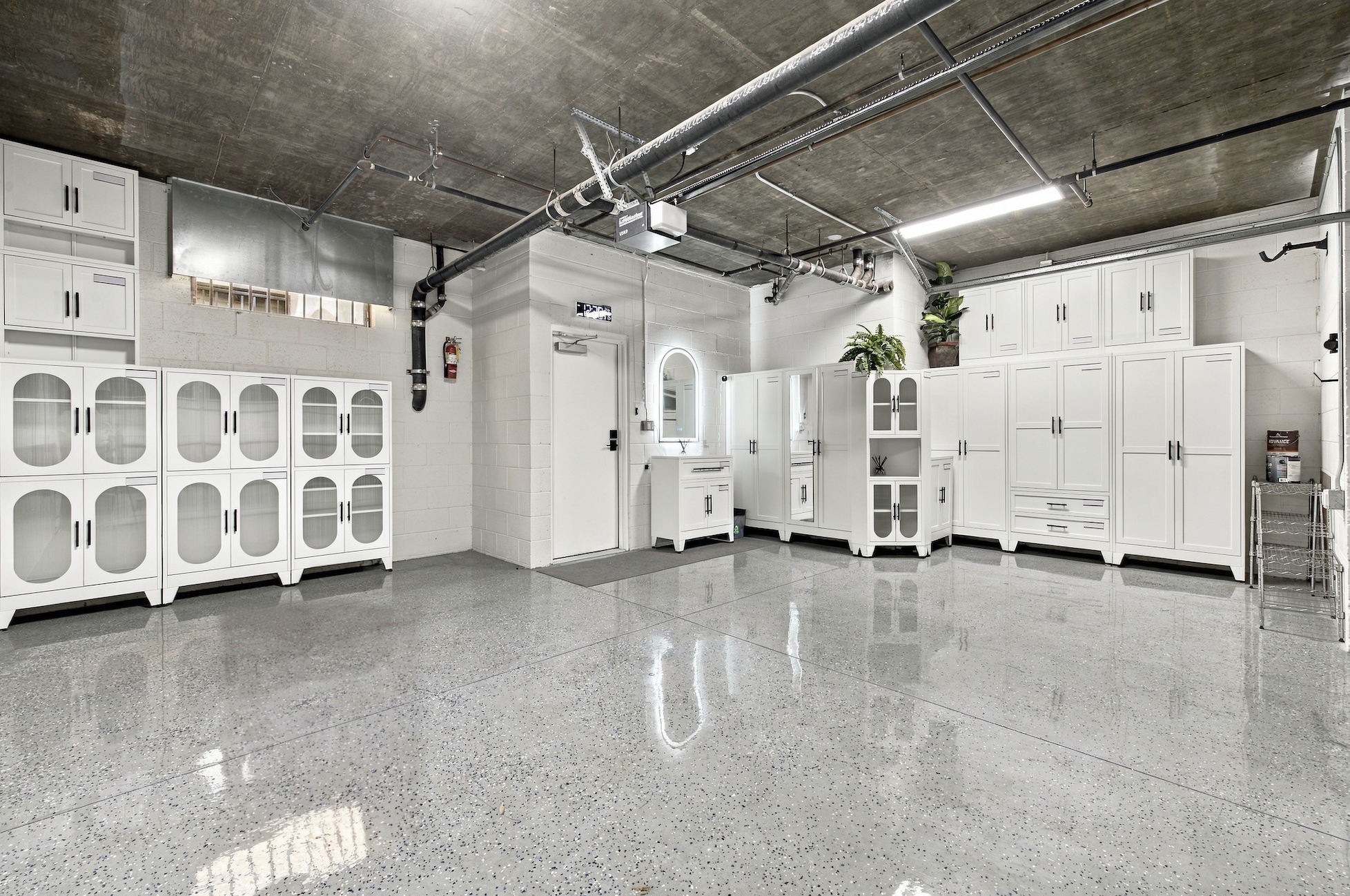 Two-car garage equipped with vanity station, extensive wall storage, and LiftMaster opener