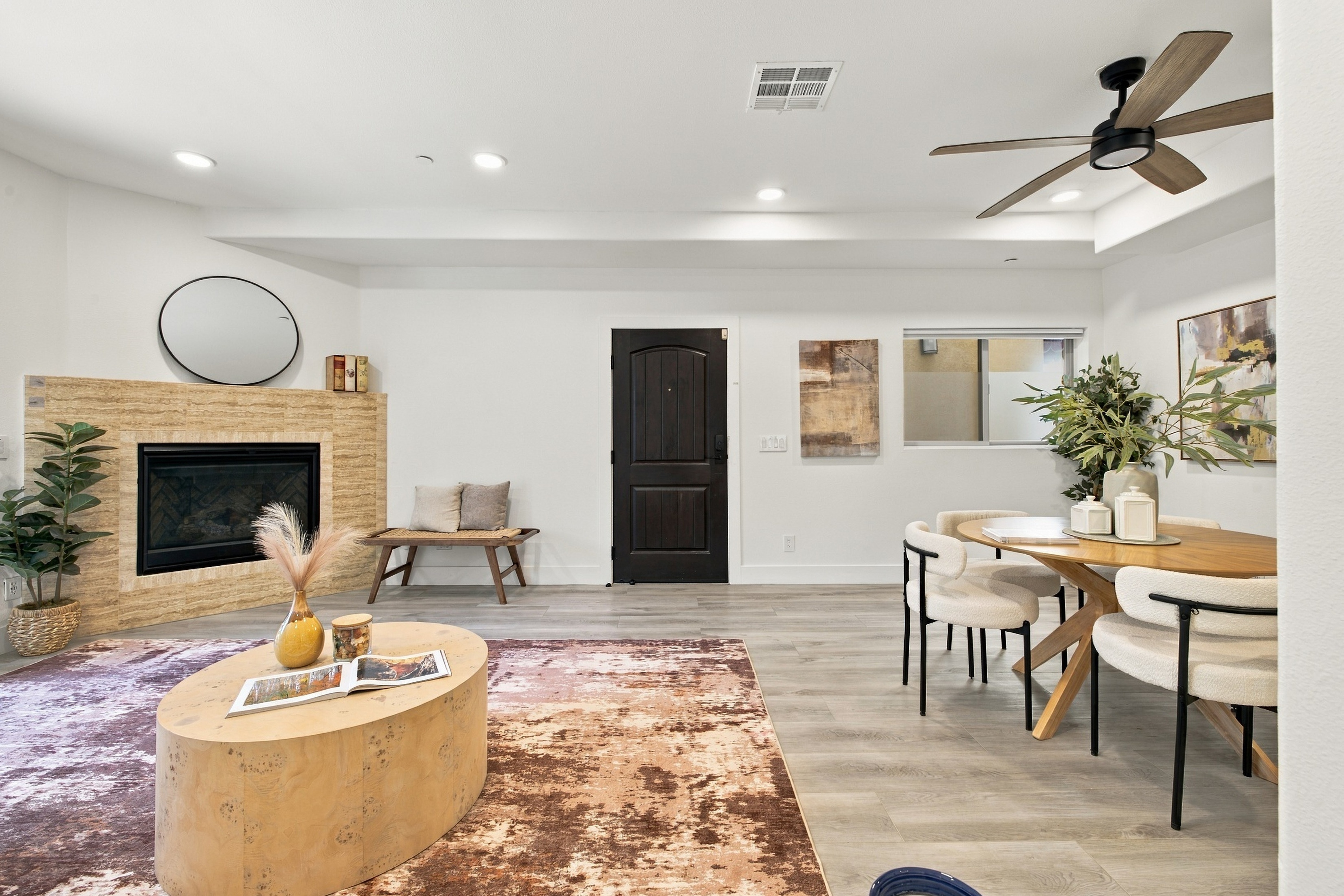 Living and dining space with contemporary fireplace and modern ceiling fan