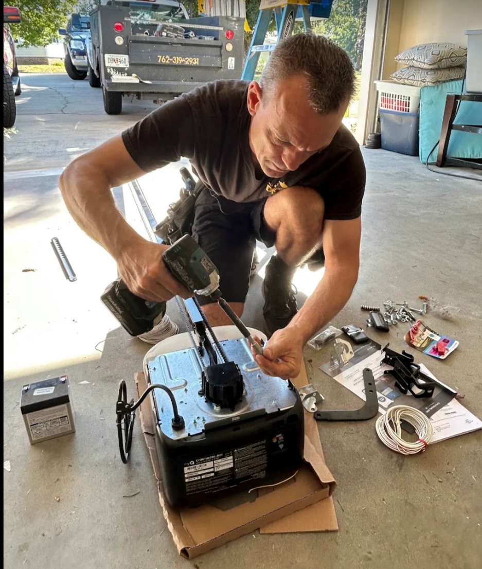 All Access Garage Doors technician Jeff working on a garage door opener with a drill in Thomaston, GA