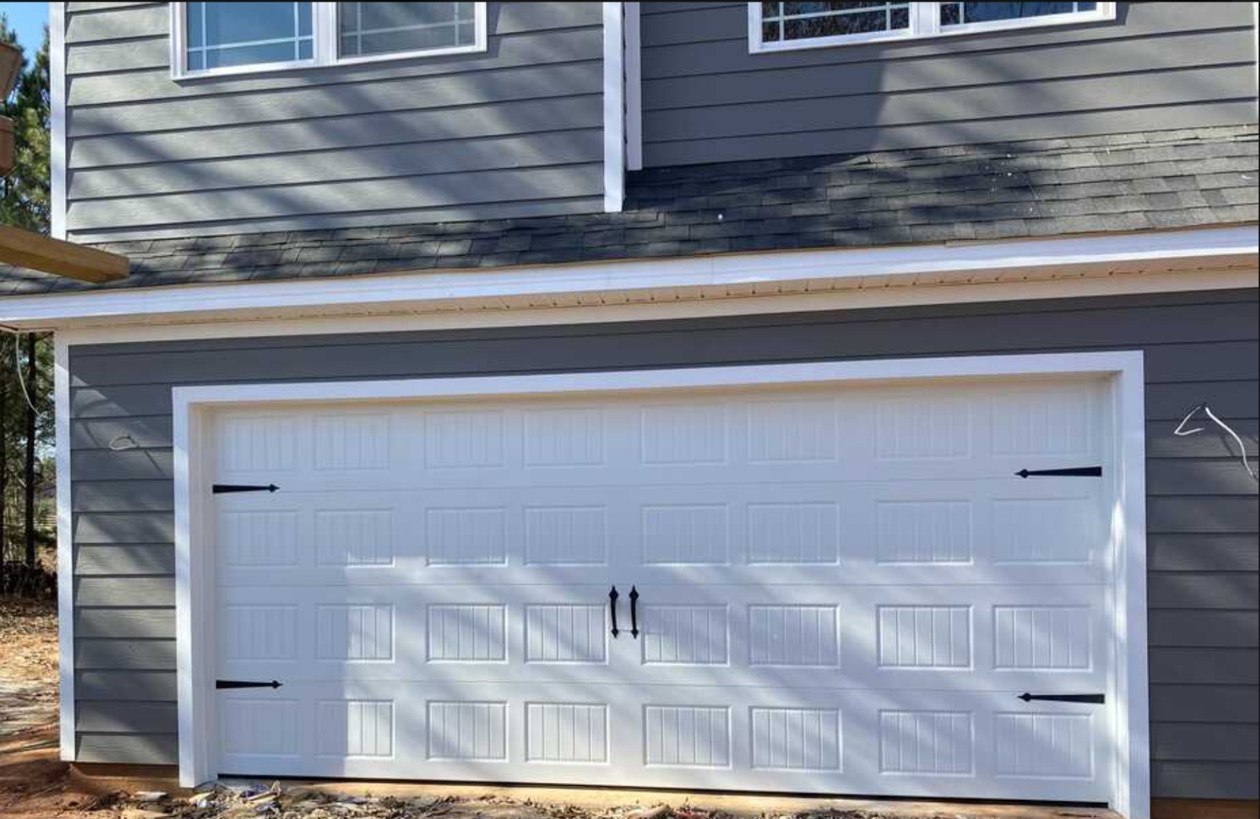 Residential garage door replacement with new panels and hardware in Thomaston, GA