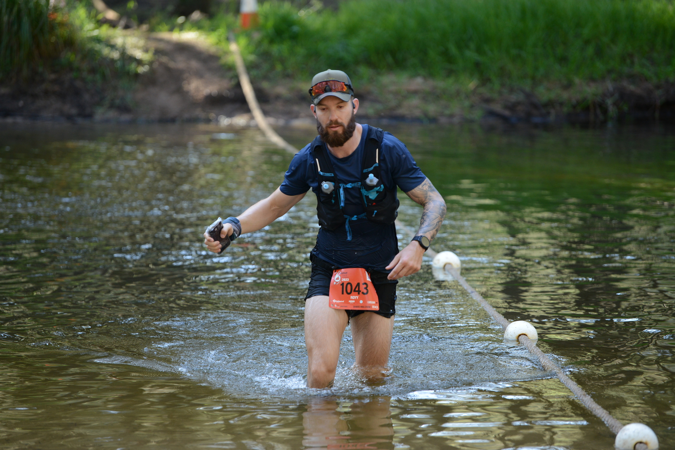 Shard Malchow managing a river crossing during an ultra race