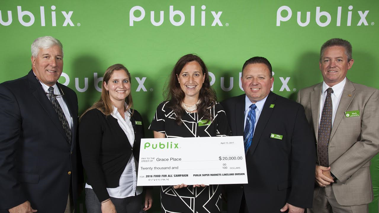 Charity campaign check presentation celebrating fundraising impact