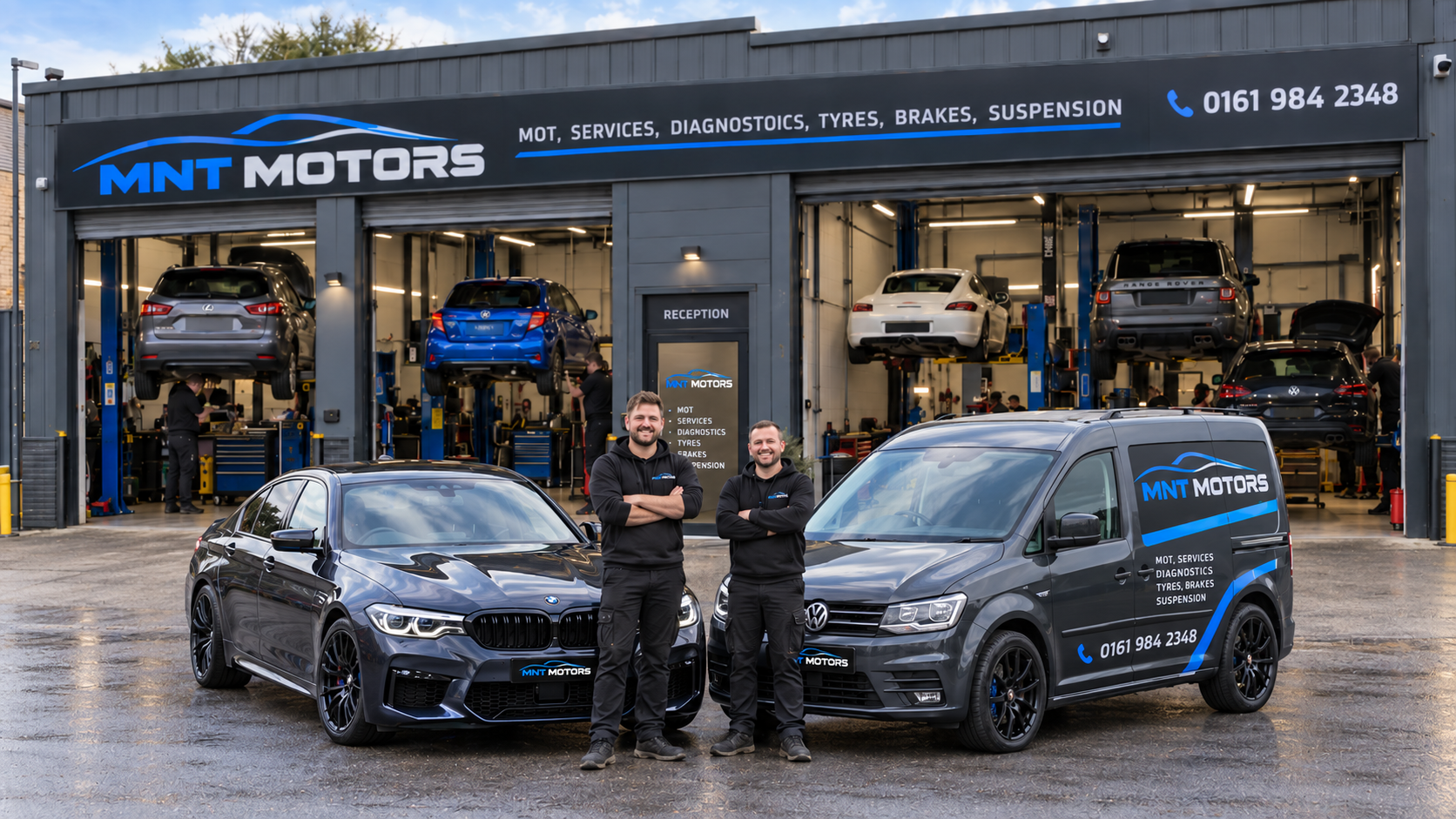 MNT Motors independent workshop with customer vehicles on hydraulic lifts and business owners standing beside vehicles