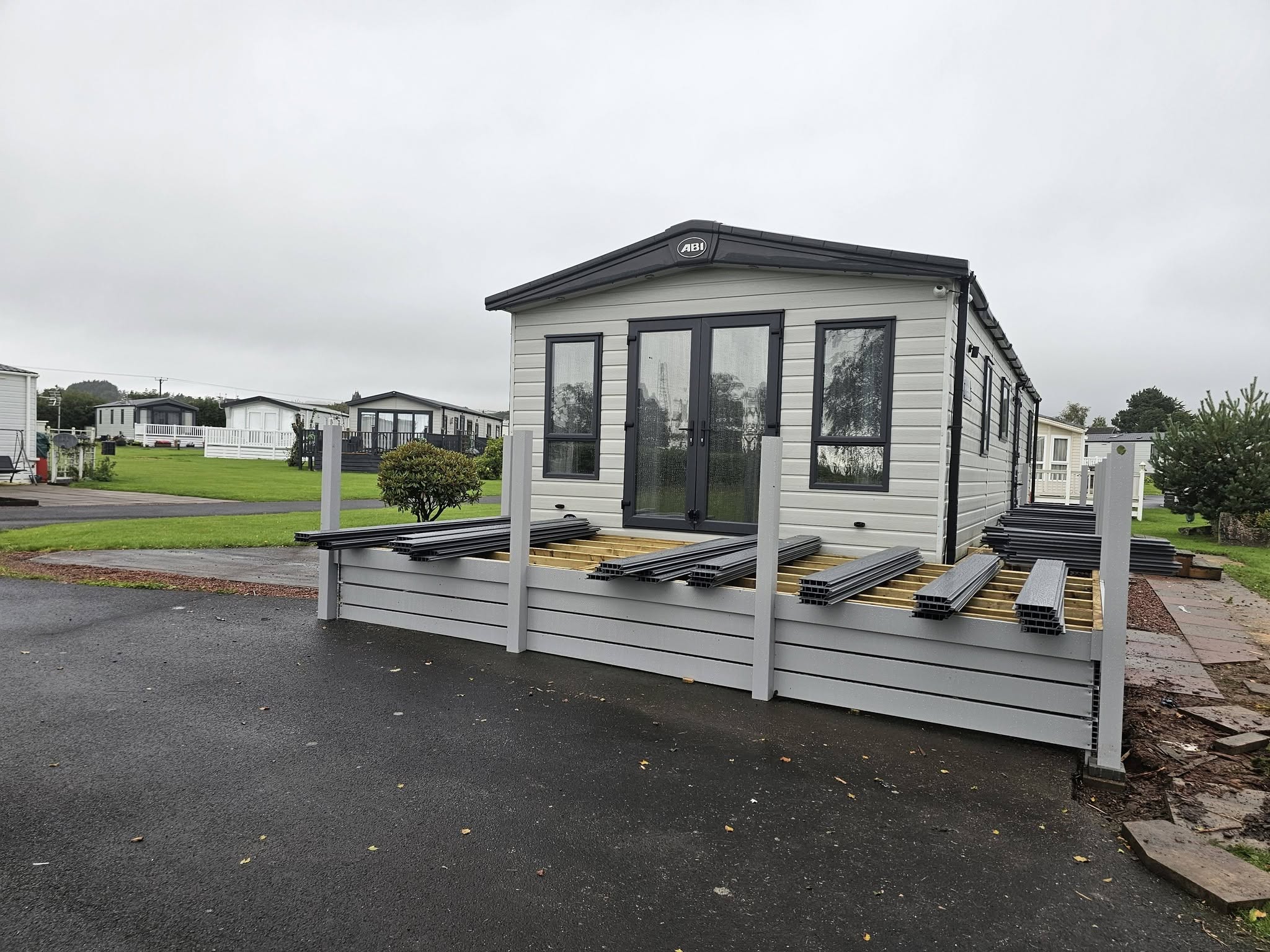 Modern ABI lodge exterior with spacious decking on park plot
