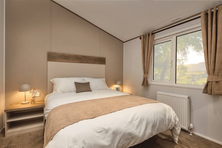 Comfortable master bedroom with scenic countryside window