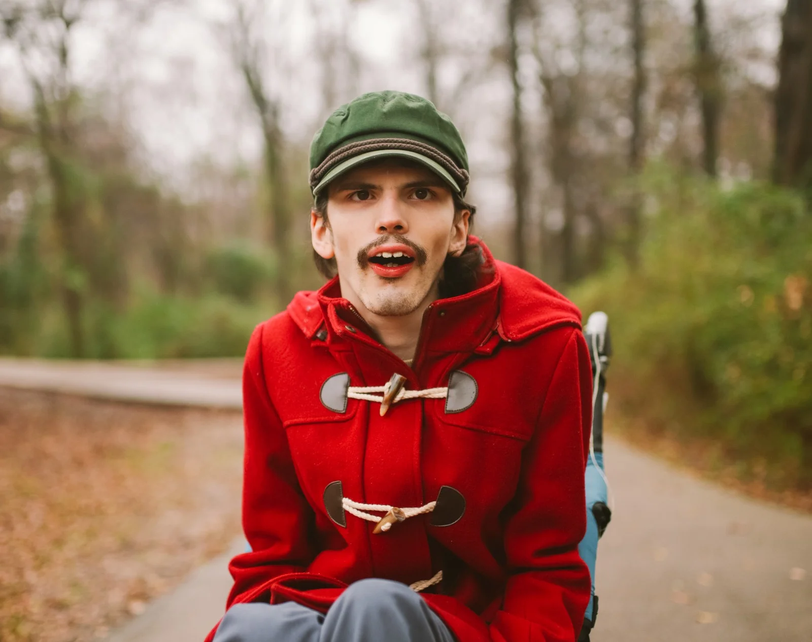 Compassionate outdoor walk with a young adult in red coat expressing warmth and listening