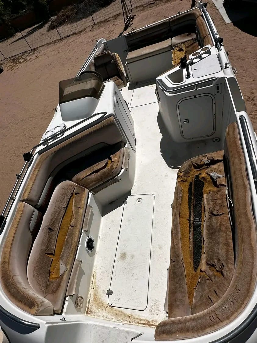 Boat interior before upholstery restoration with torn and sun-rotted vinyl