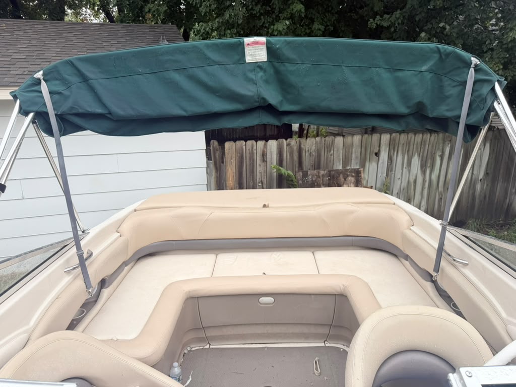 Boat rear seating and marine upholstery with green bimini top canopy