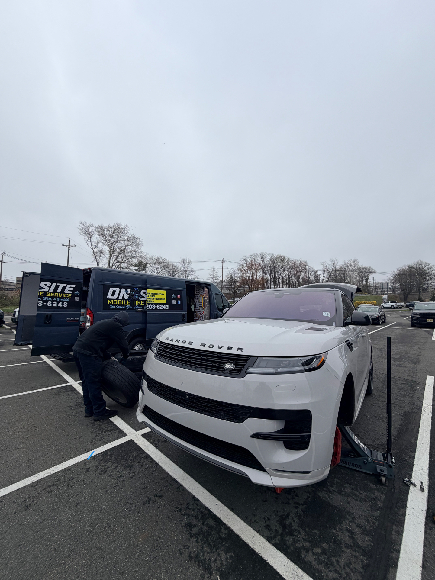 Range Rover Sport getting mobile tire service in a parking lot - On Site Mobile Tire Service
