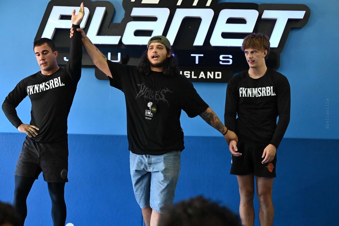 Fusion Jiu-Jitsu competitor having hand raised in victory at tournament match