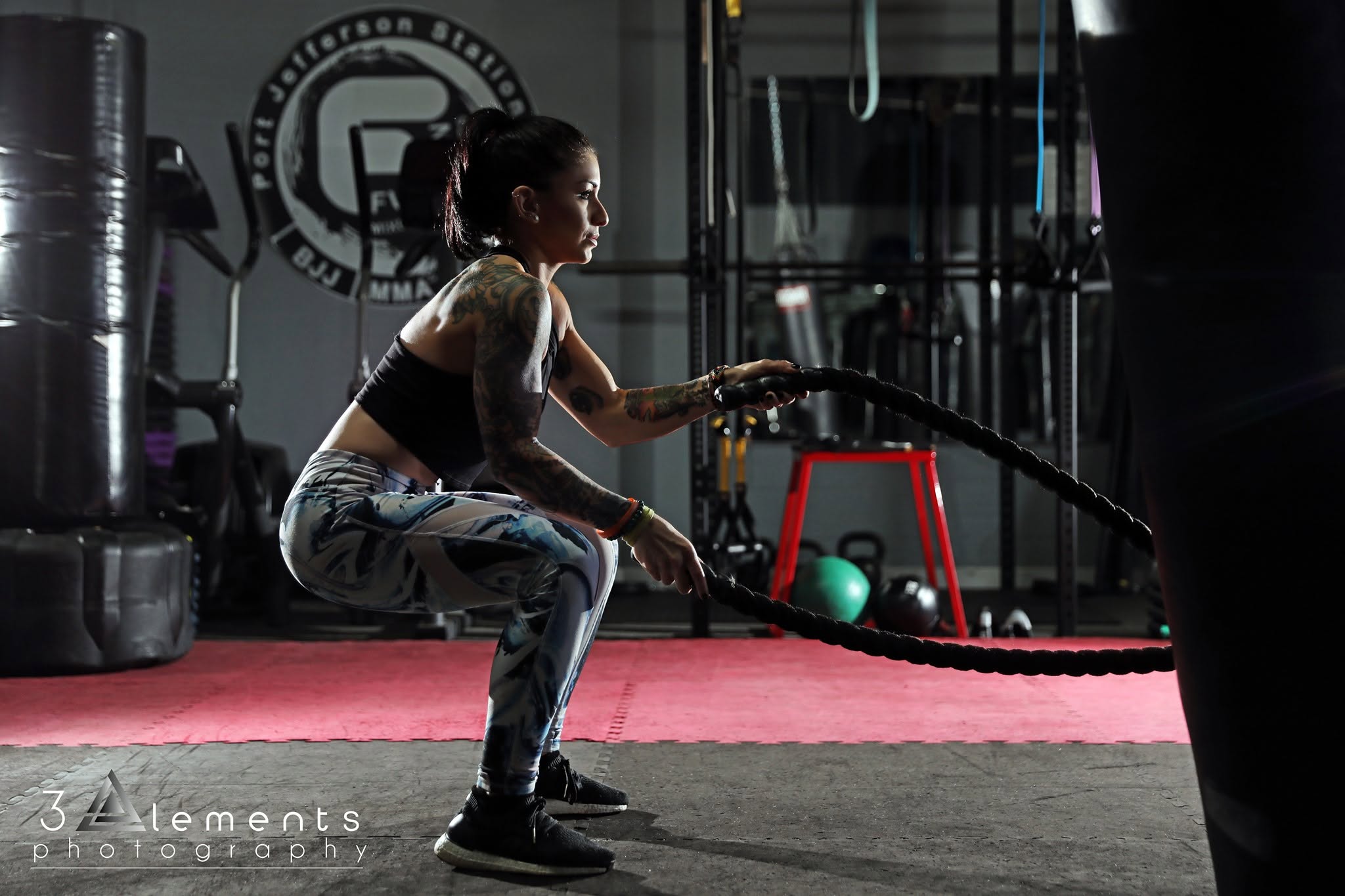 Fusion member performing battle ropes in X-Training circuit