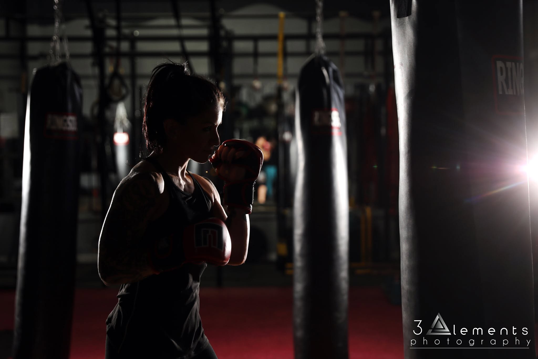 Fusion member throwing kicks and strikes on the heavy bag