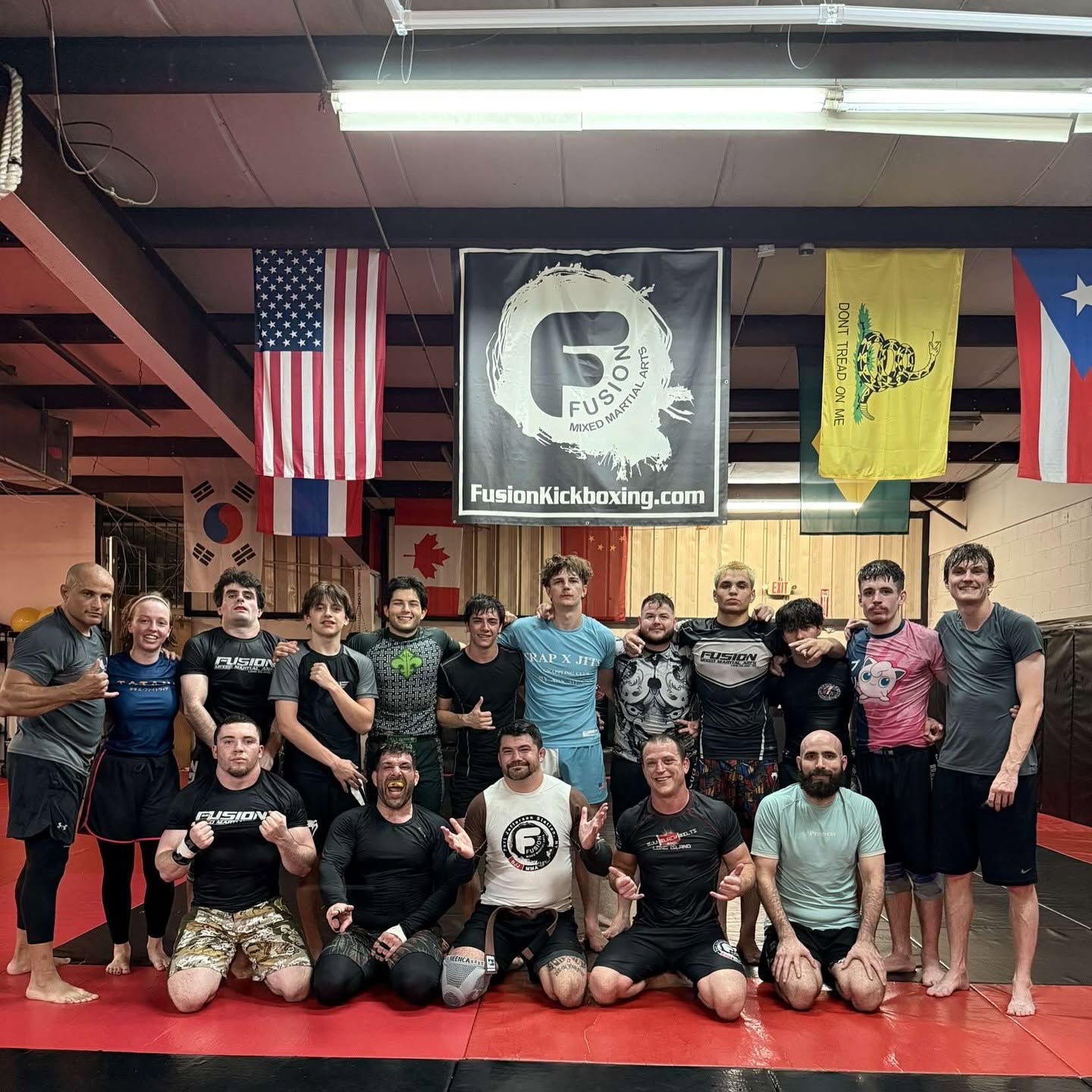 Fusion No-Gi Jiu-Jitsu team on the mats under the gym banner