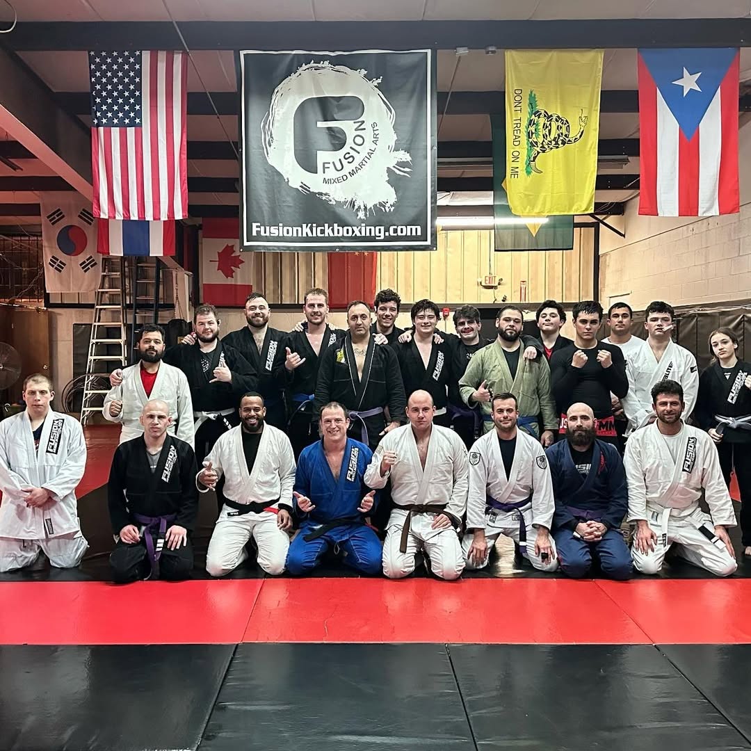 Fusion Gi Jiu-Jitsu class and team in uniform on the mats