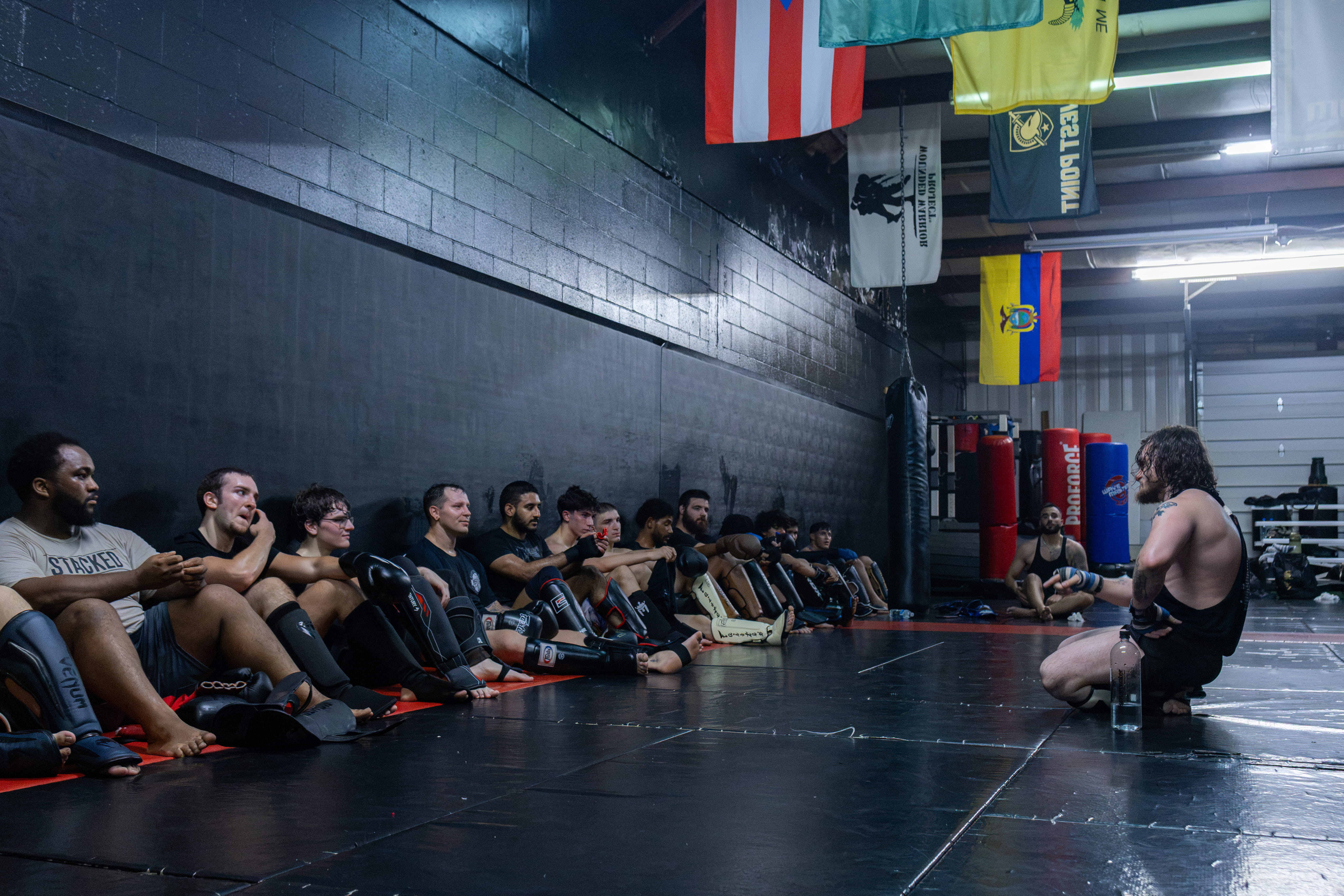 Fusion Muay Thai coach instruction and team mat discussion