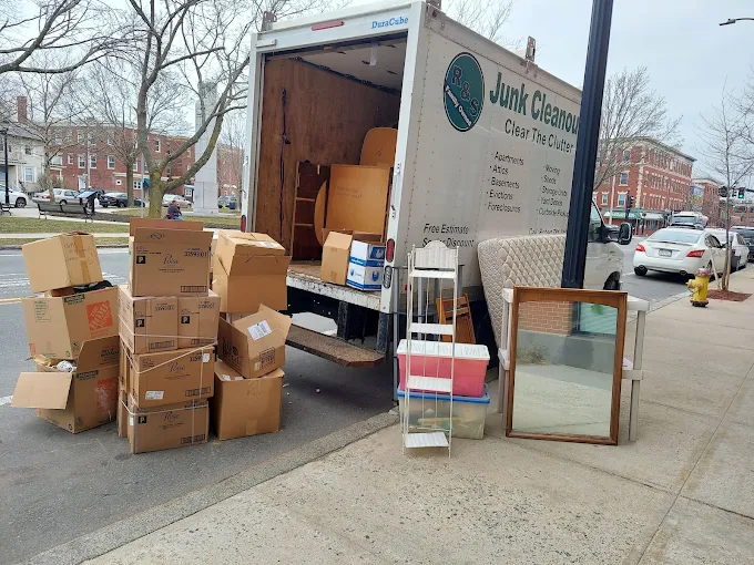 Official R&S Junk Cleanouts truck loaded with furniture, boxes, and cleanout items in Essex County MA