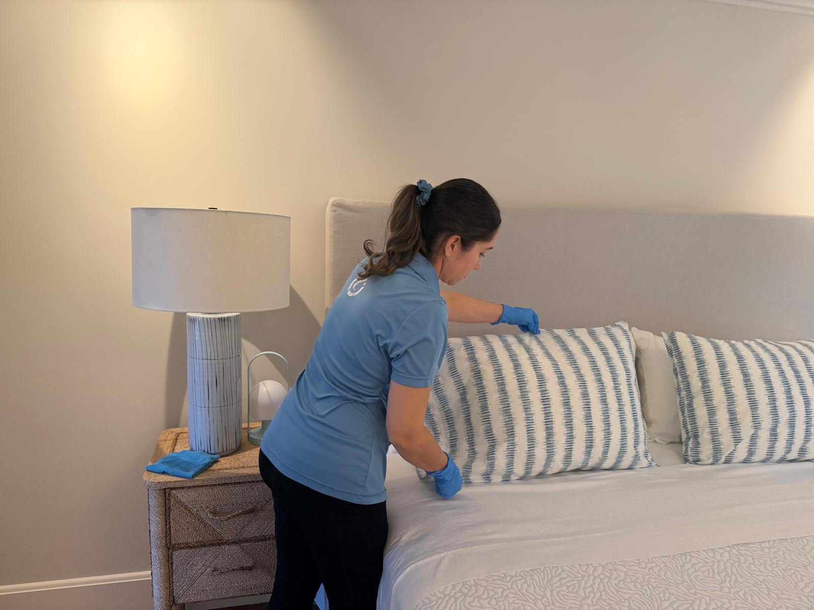 ICP Cleaning Services professional preparing guest bedroom and bed in coastal island home