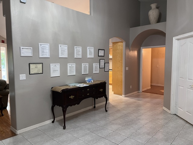 Welcoming entryway, foyer, and licensure display at Serenity Circle RTC in Mesa, AZ