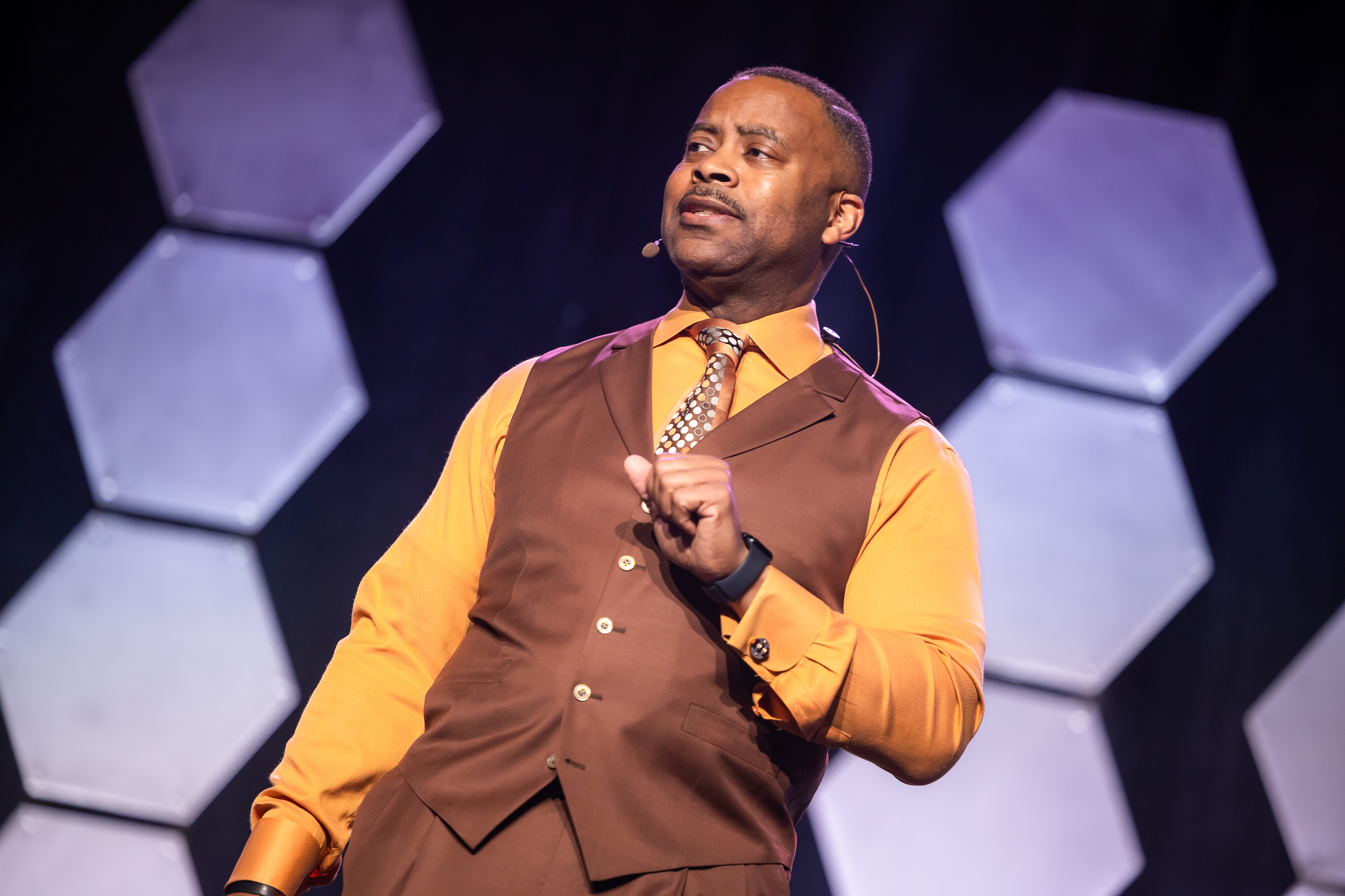 Montez Jones speaking live on stage in Arlington