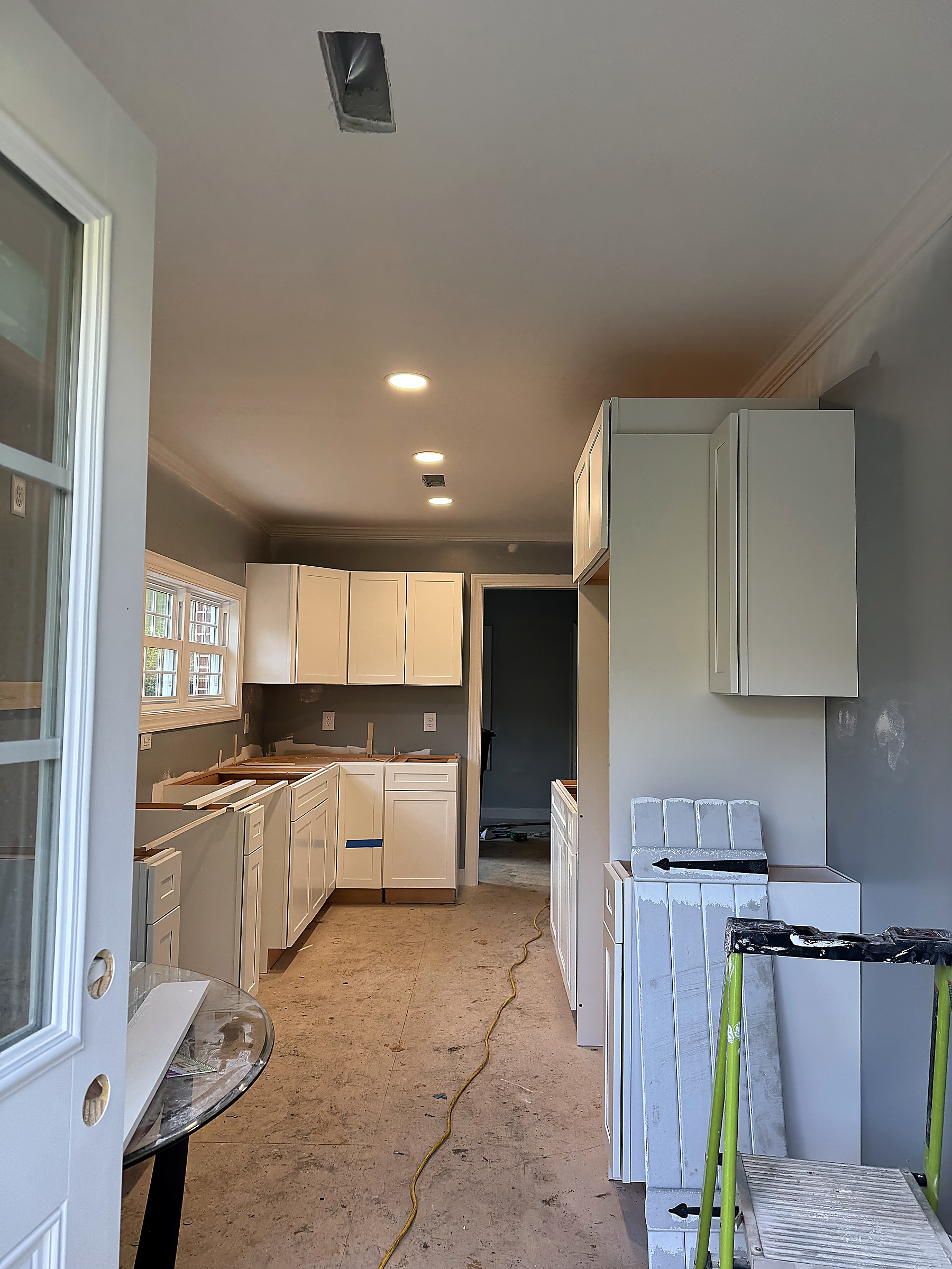 White shaker kitchen cabinets being installed during a kitchen remodel by Tucker Built Construction