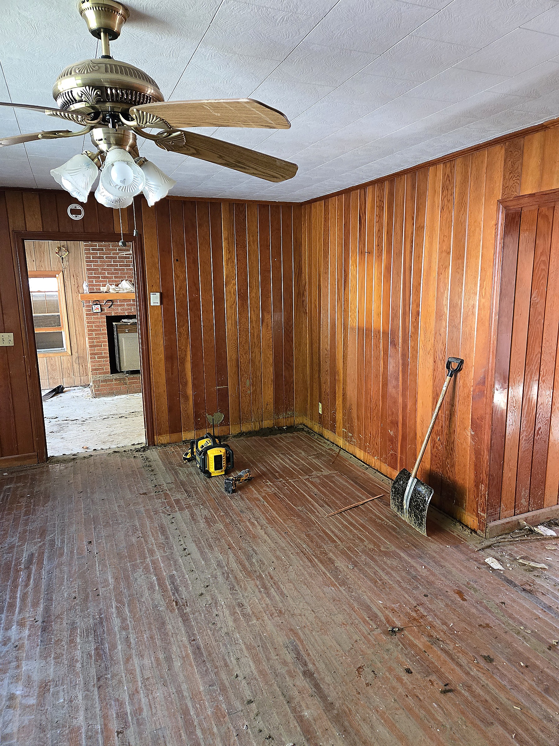 Paneled room cleared out and ready for renovation after flood damage