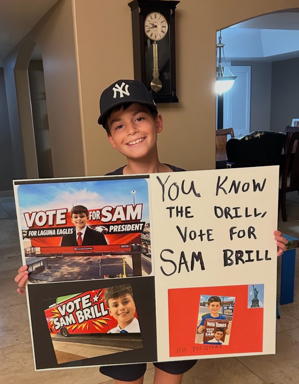 Sam holding homemade campaign poster: You Know The Drill, Vote For Sam Brill