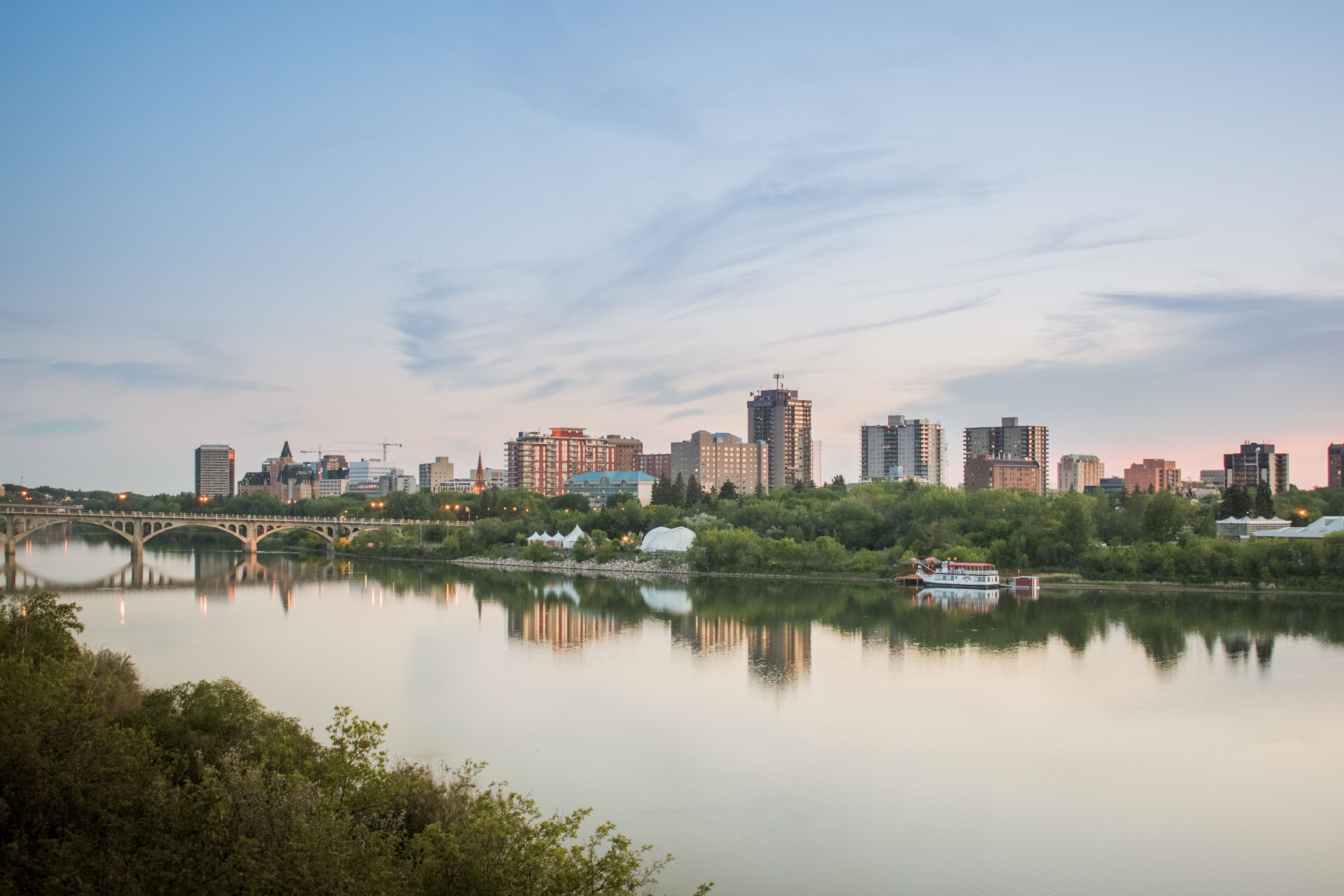 Saskatoon skyline and river reflection with pins highlighting local service businesses