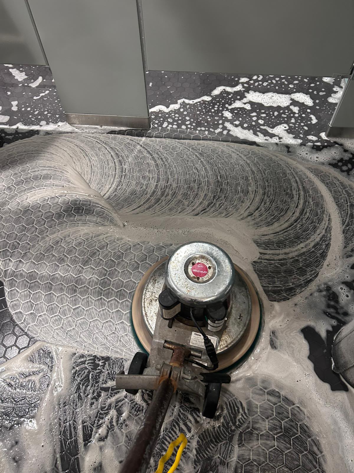 Industrial rotary floor scrubbing and deep cleaning machine in action by All Five Star MJ, Inc.