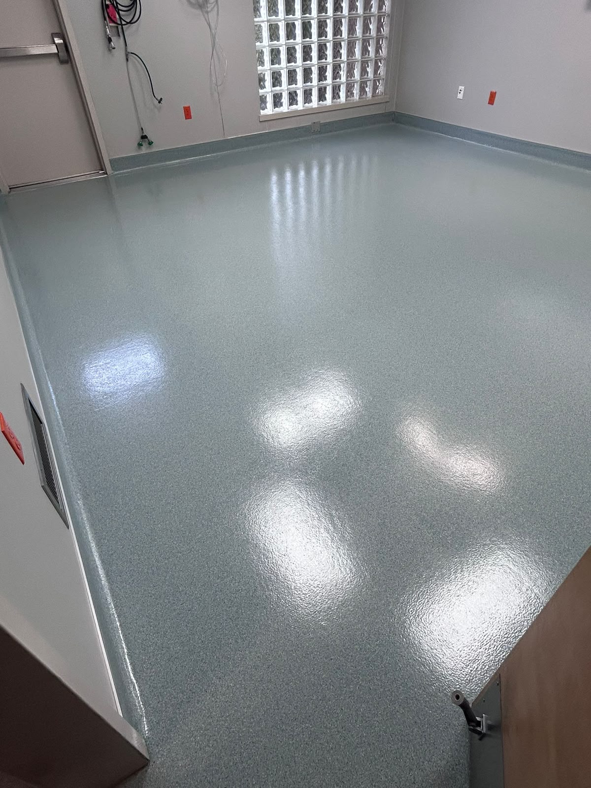 High-gloss commercial epoxy and VCT floor finish in clinical facility by All Five Star MJ, Inc.