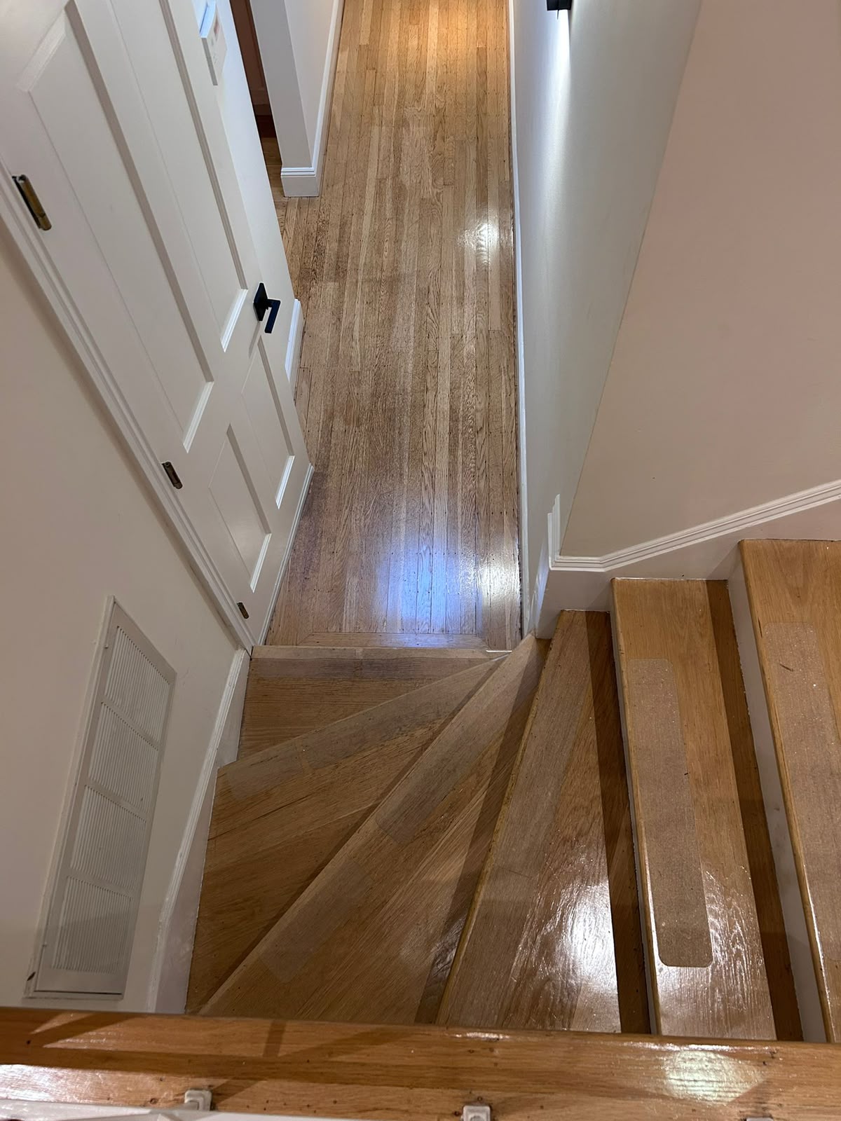 Polished hardwood stairs and hallway floor restoration by All Five Star MJ, Inc.