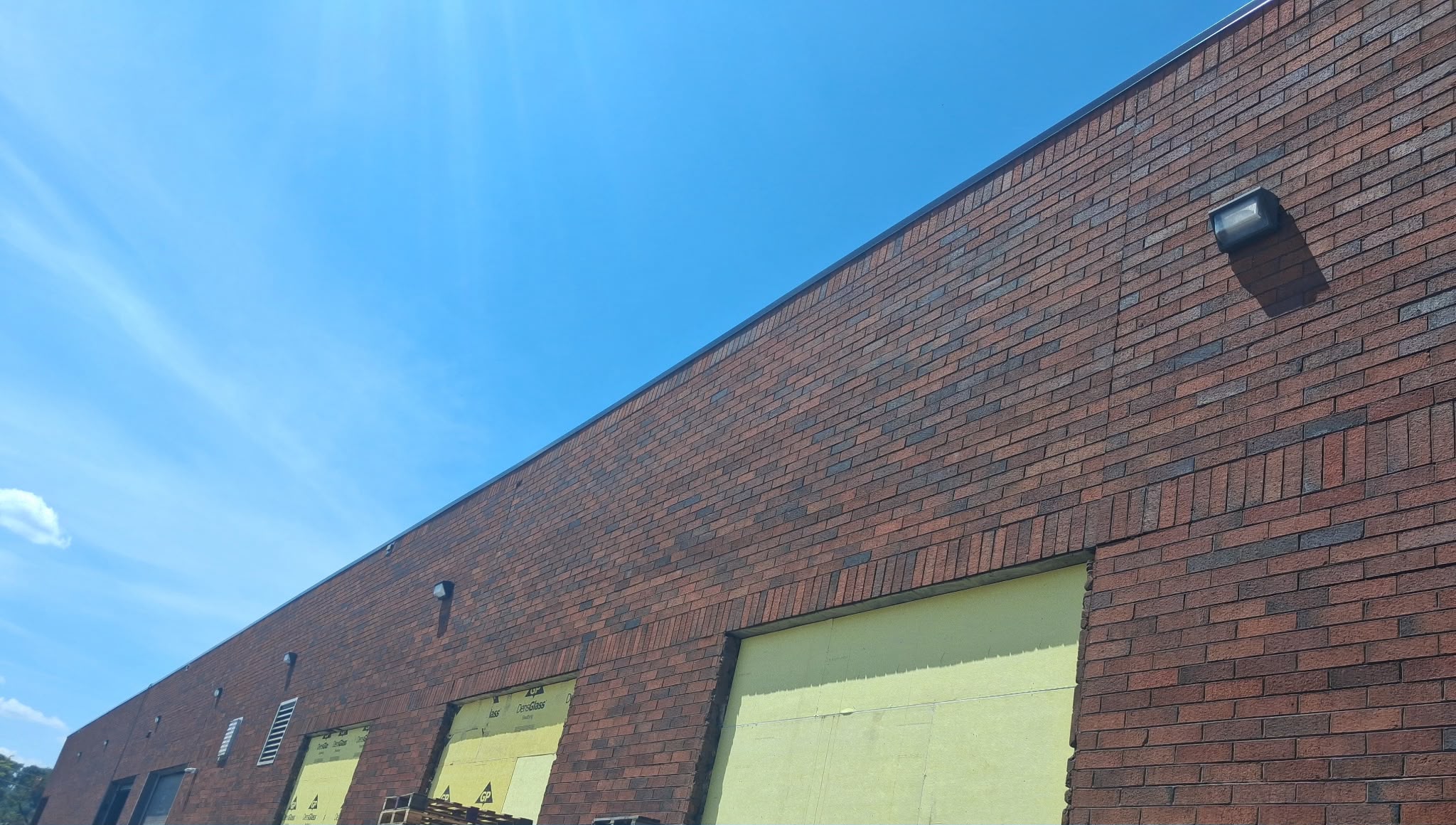 Commercial building exterior wall pack lighting installation by Anaeli GM Electric LLC