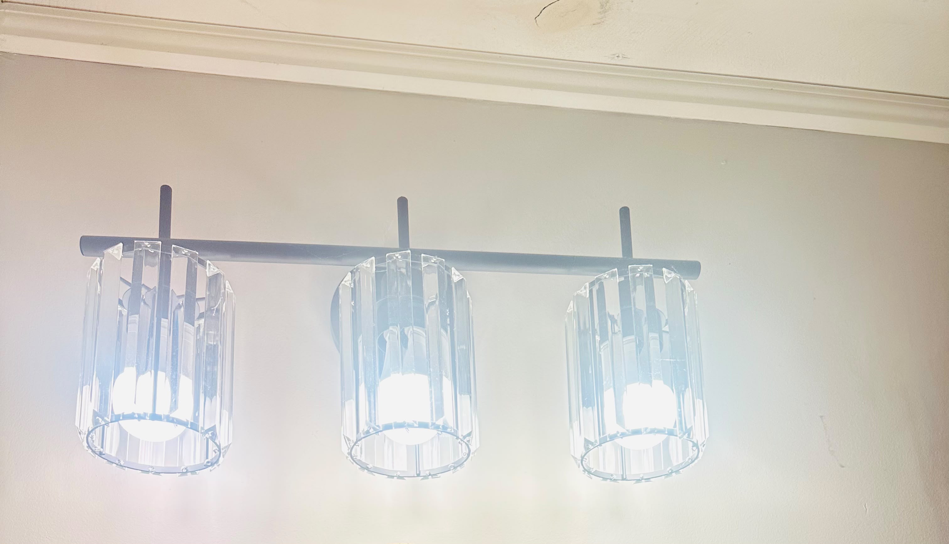 Modern vanity light fixture installation by Anaeli GM Electric LLC