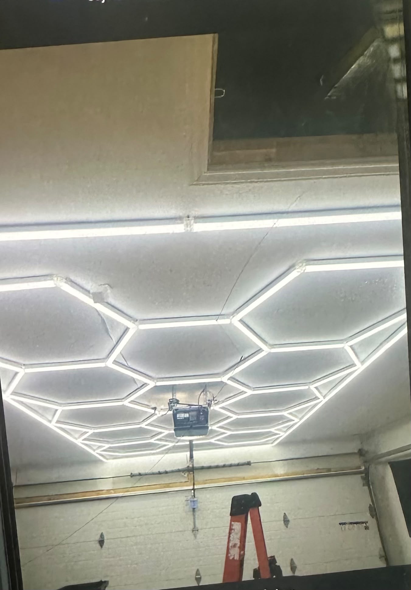 Custom hexagon honeycomb LED ceiling lighting installation in garage workshop by Anaeli GM Electric LLC