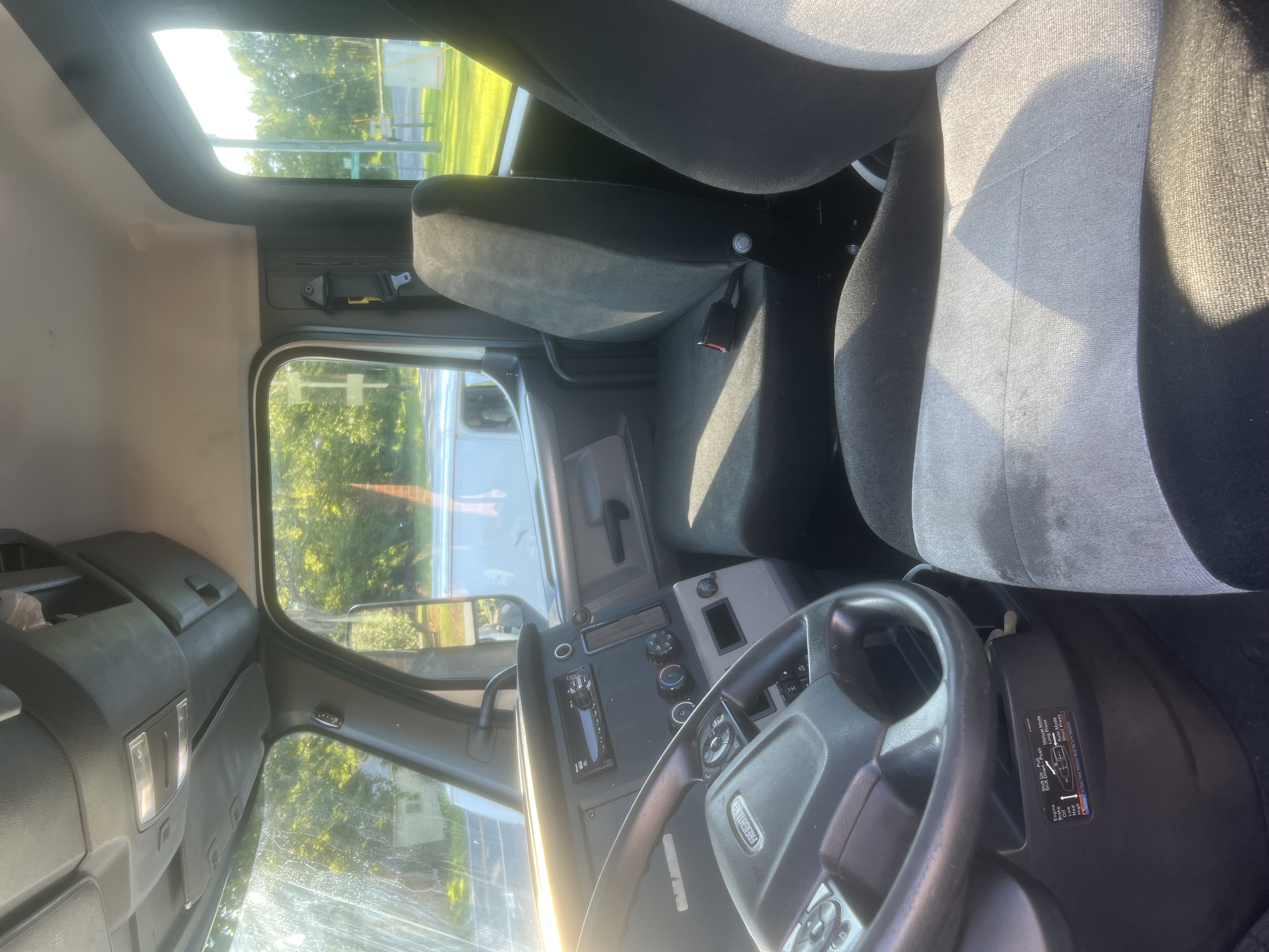Commercial truck interior cab with a clean steering wheel and dashboard