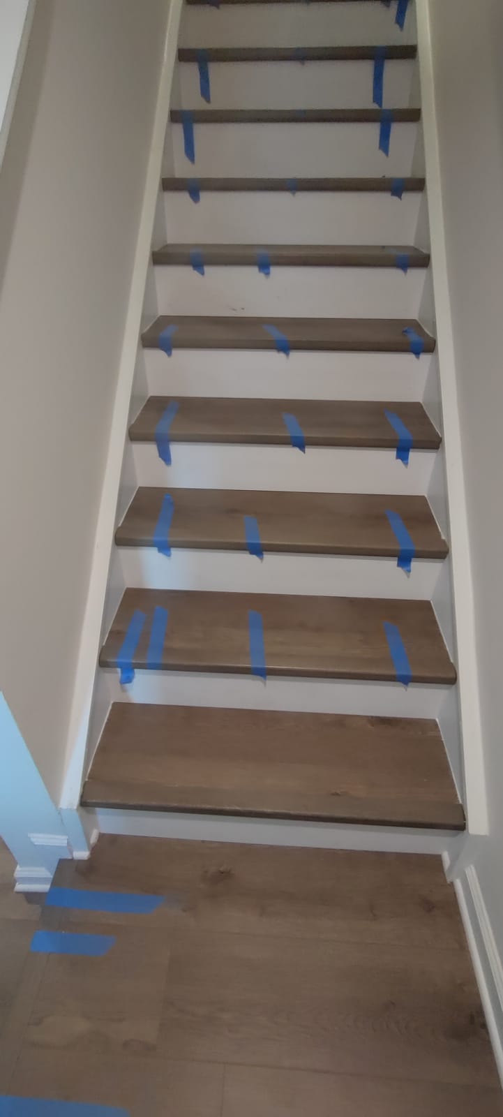 Finished residential LVP staircase with matching lower landing floor installed by Rvicente Remodeling LLC in Clemson SC