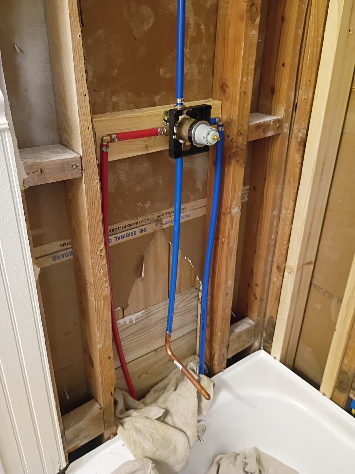 Rough-in PEX plumbing lines and shower mixing valve installation over tub by Roberto Vicente in Easley SC